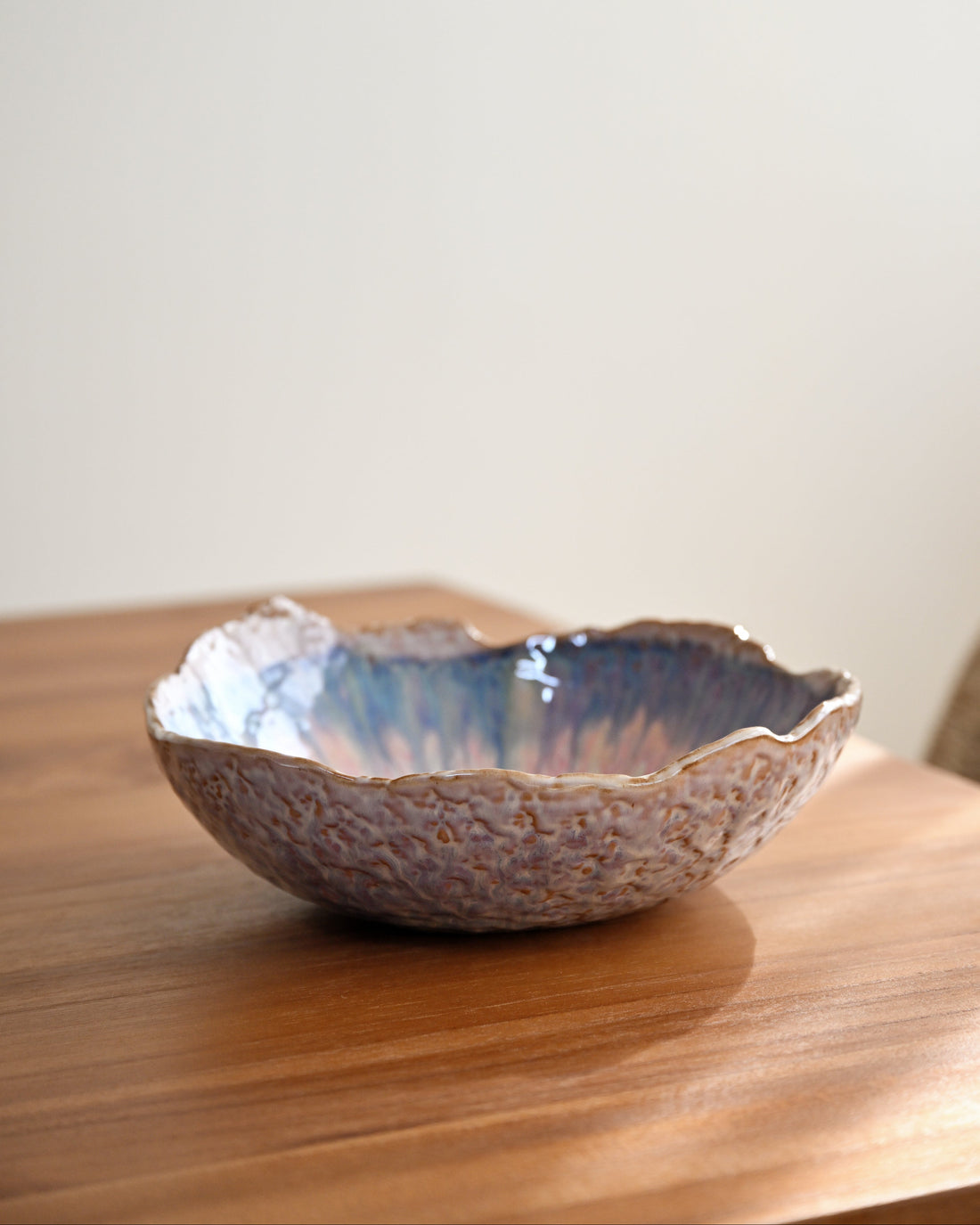 Ceramic bowl with textured surface on a wooden surface