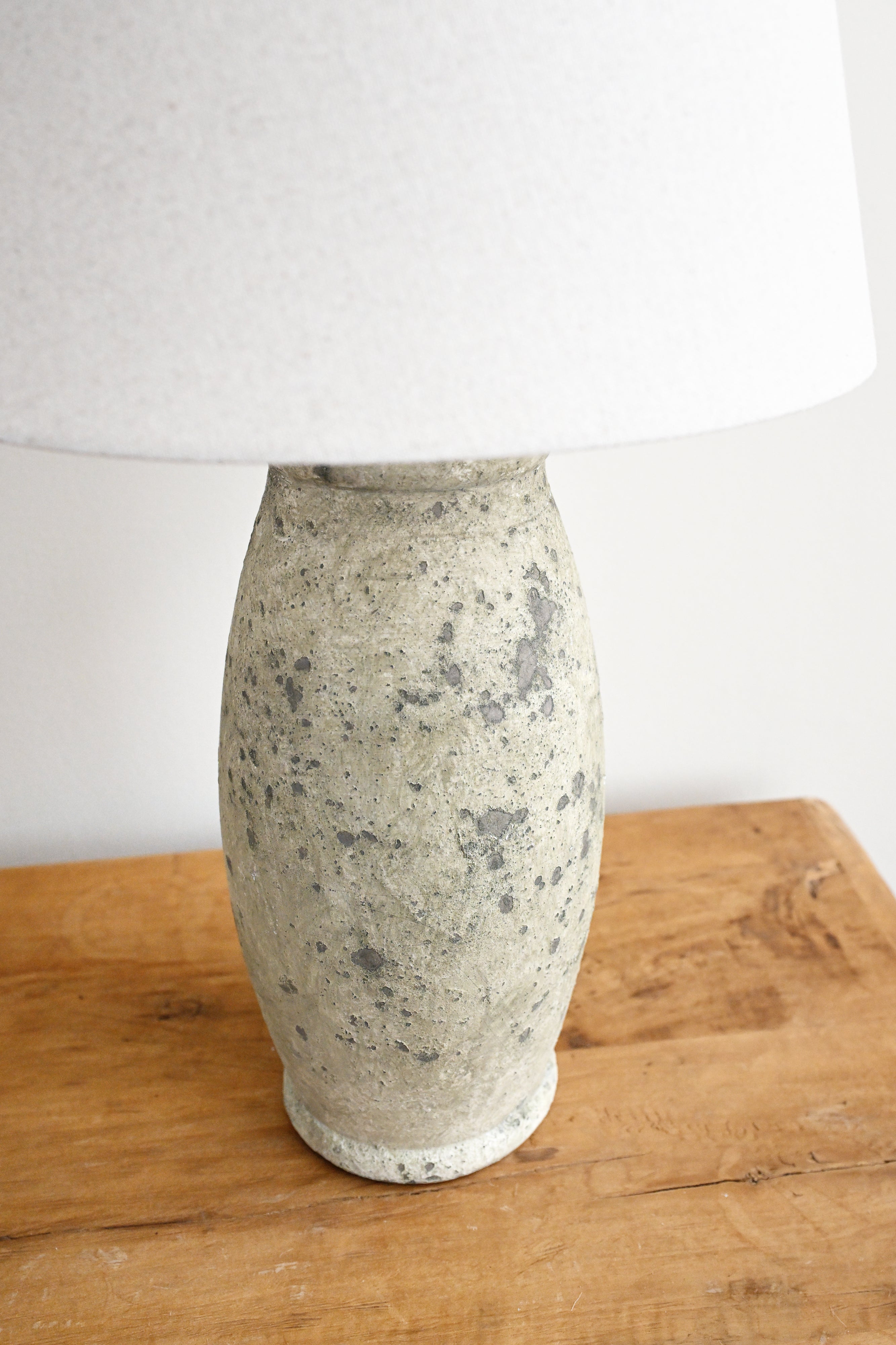 Ceramic vase on a wooden surface with a white background
