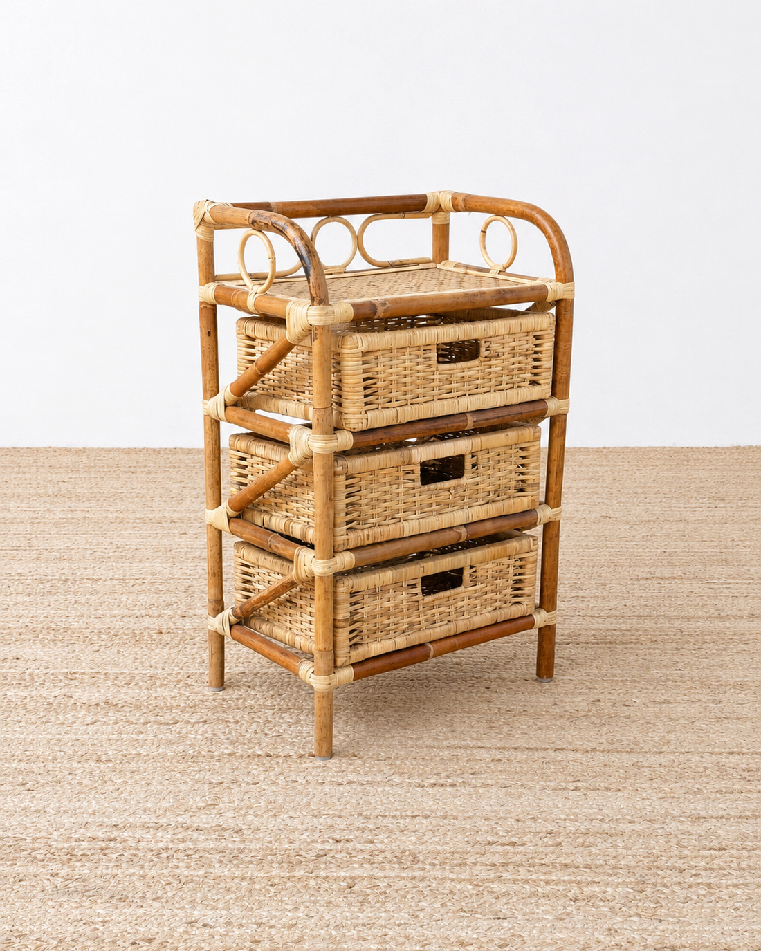 Rattan storage tower with drawers on a neutral background