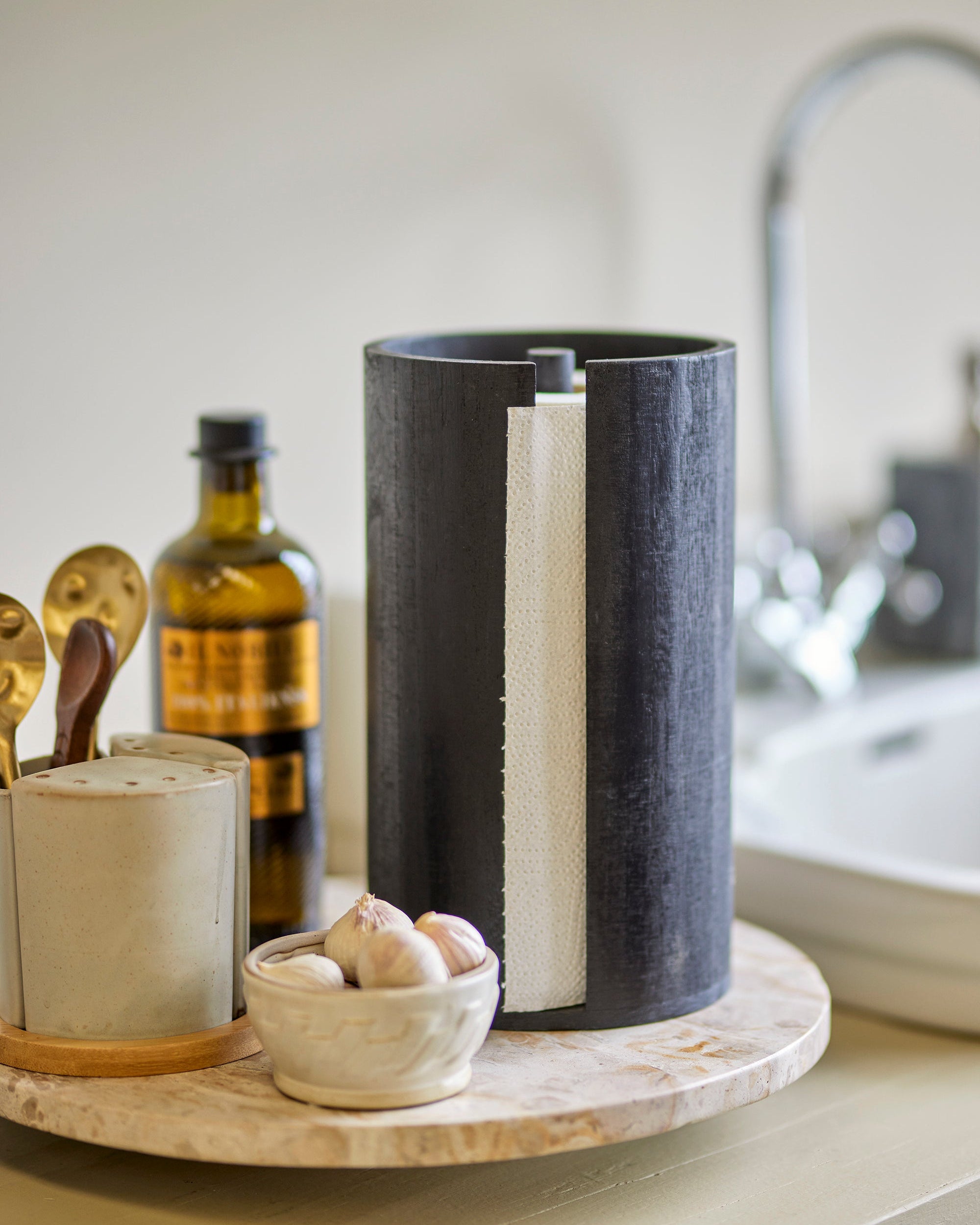 Black cylindrical container with white interior on a kitchen counter