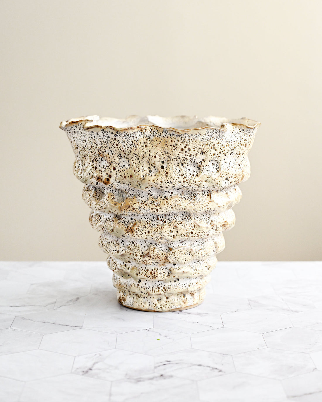 Decorative vase with textured surface on a light background