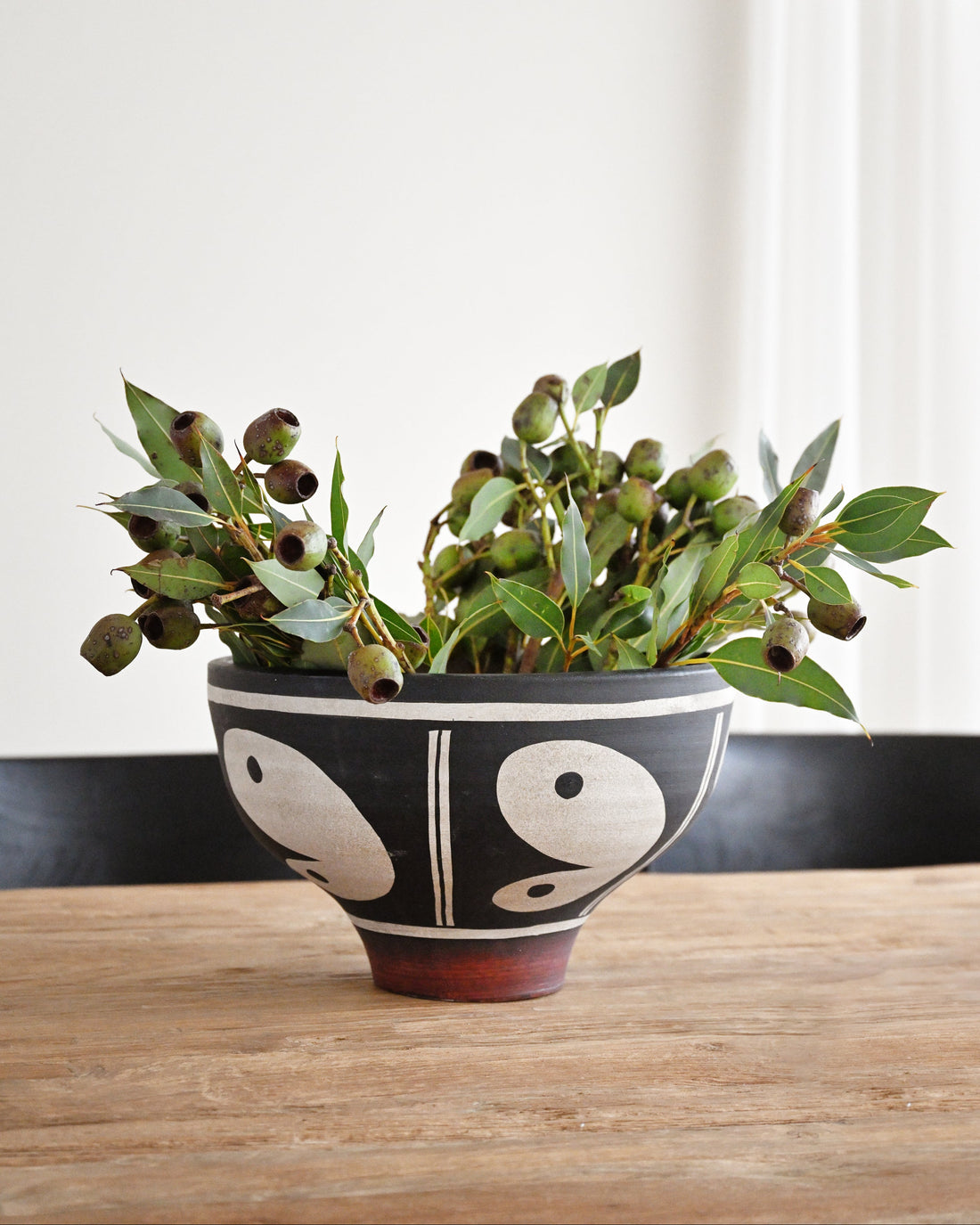 Decorative bowl with plants on a wooden table