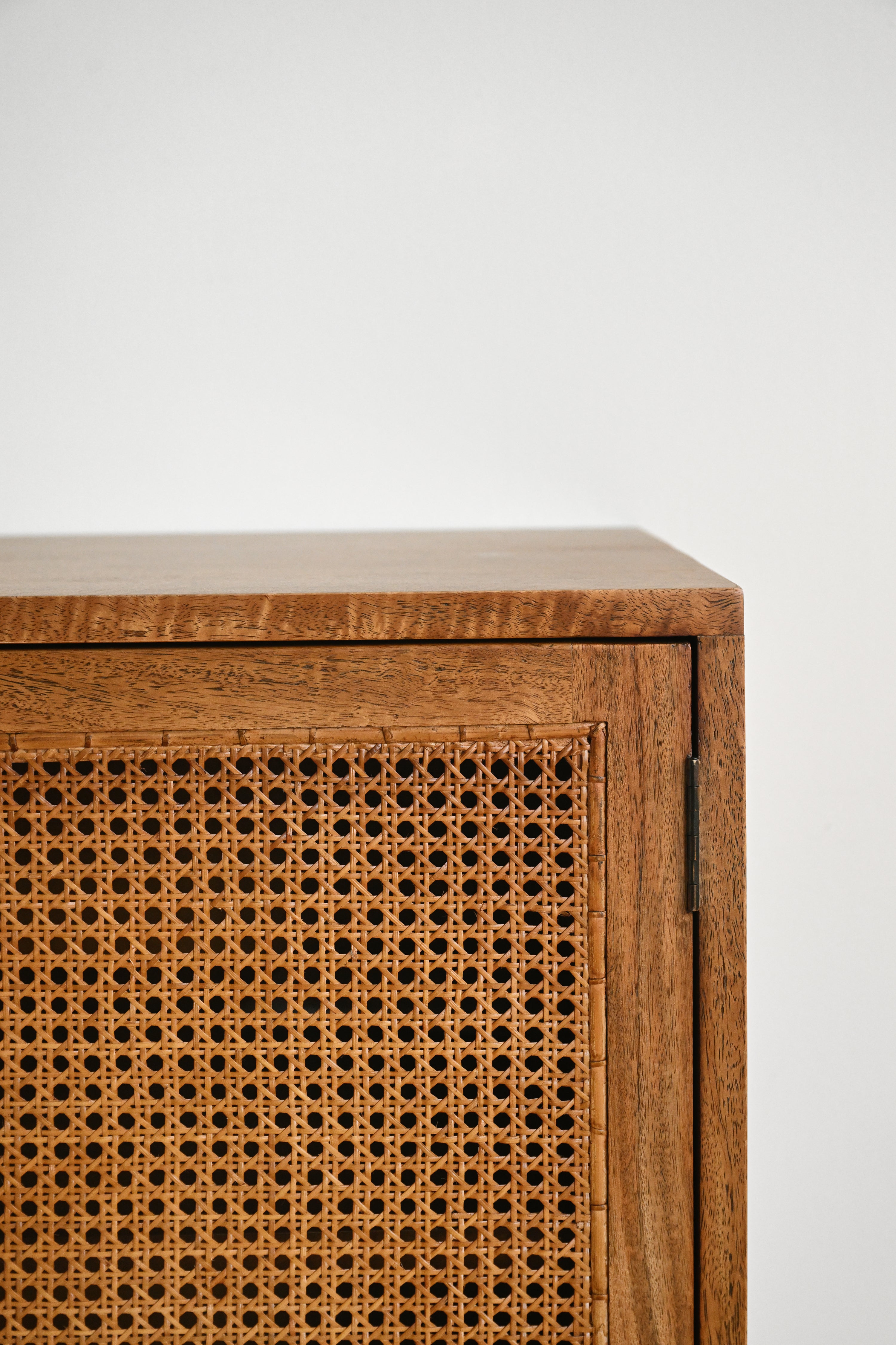 Wooden cabinet with wicker door on a white background