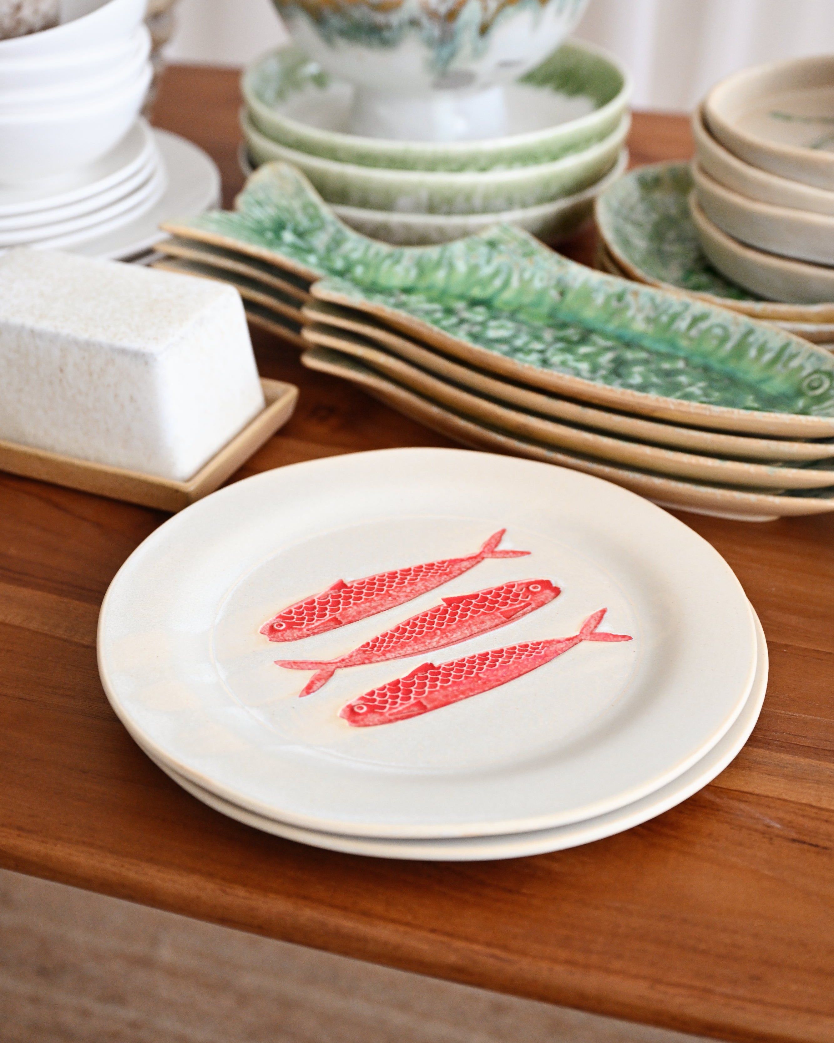 Dishes with fish design on a wooden table