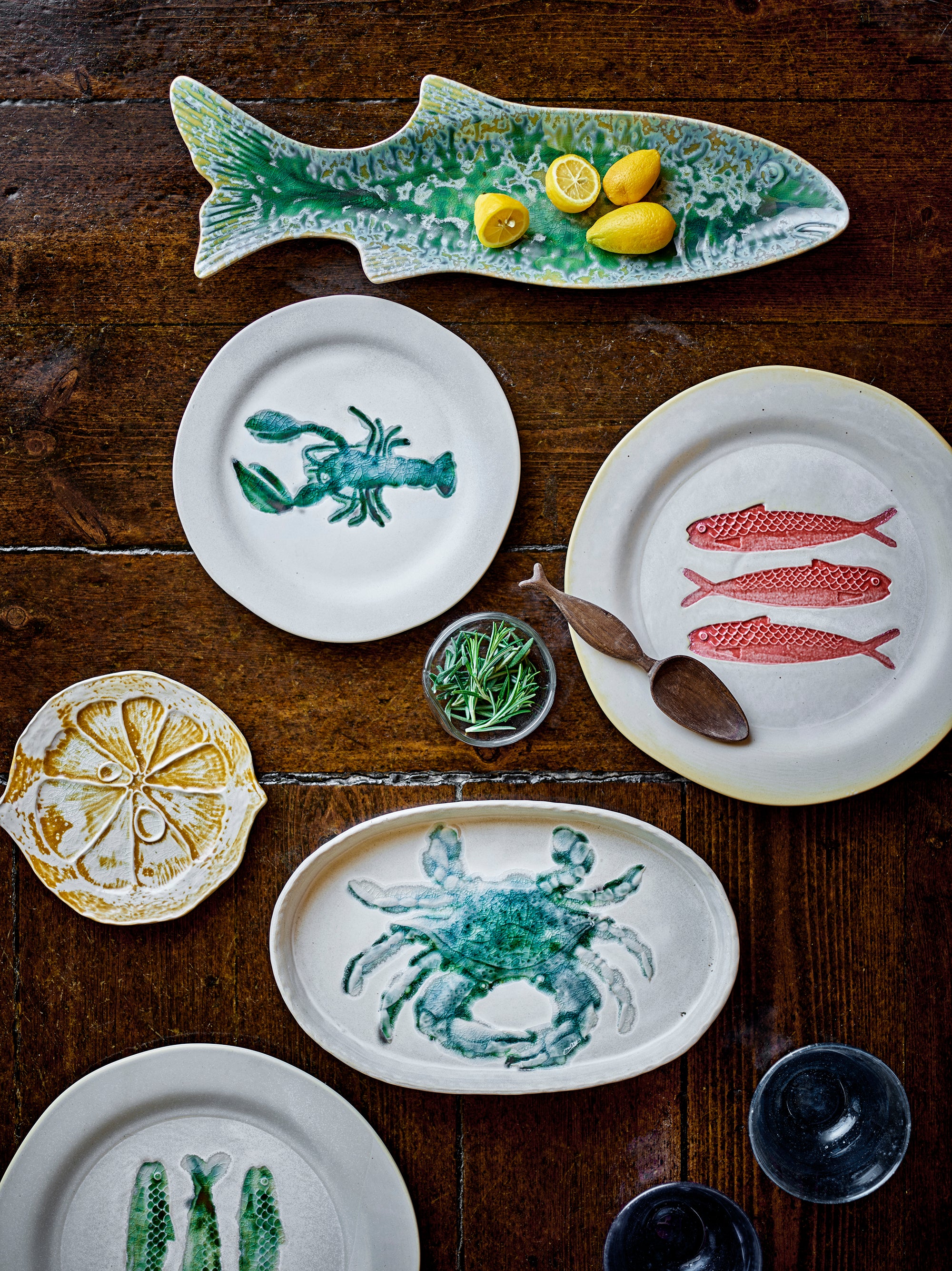 Collection of ceramic plates with animal designs on a wooden surface