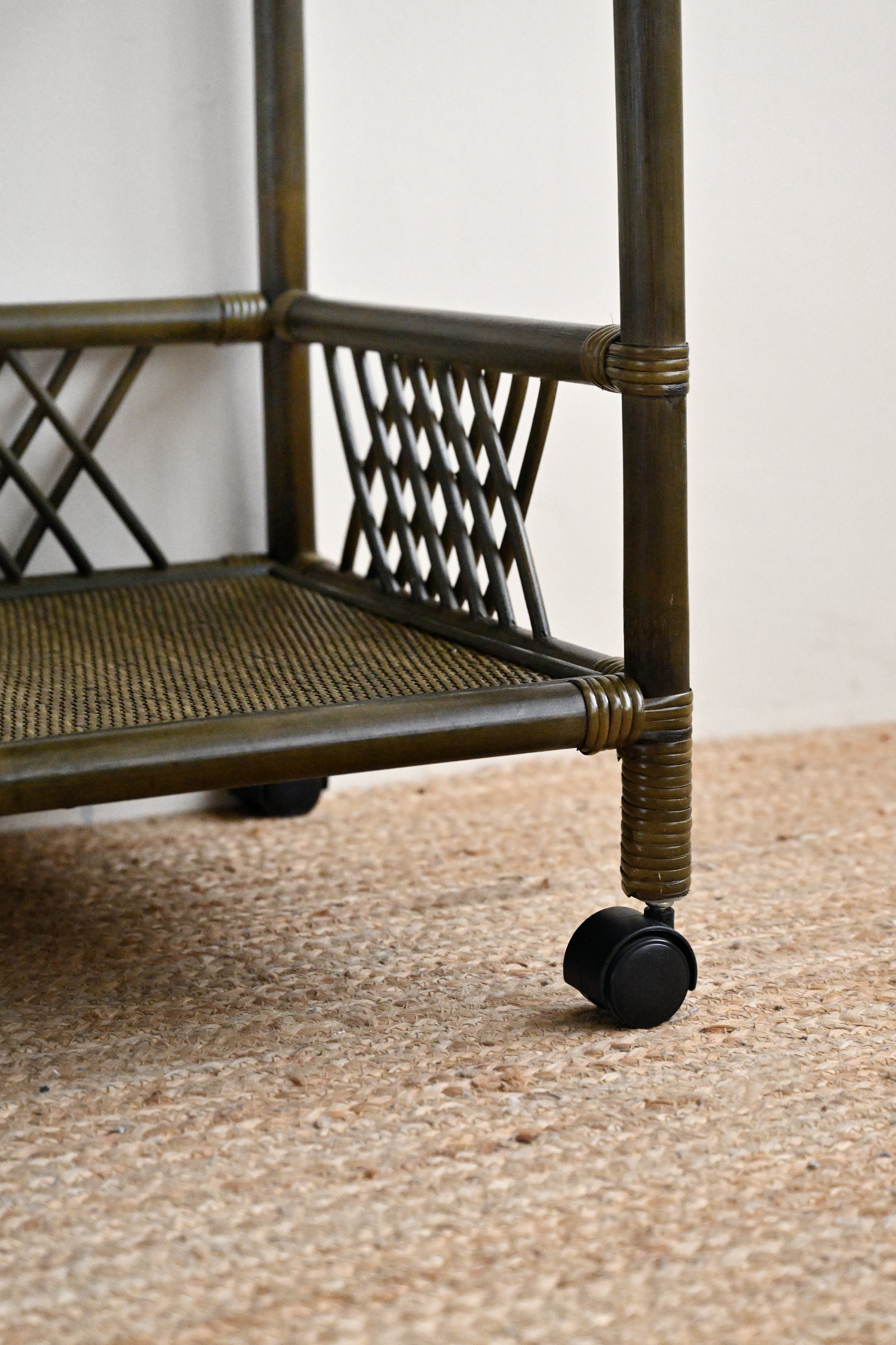 Metal cart with wheels on a textured surface