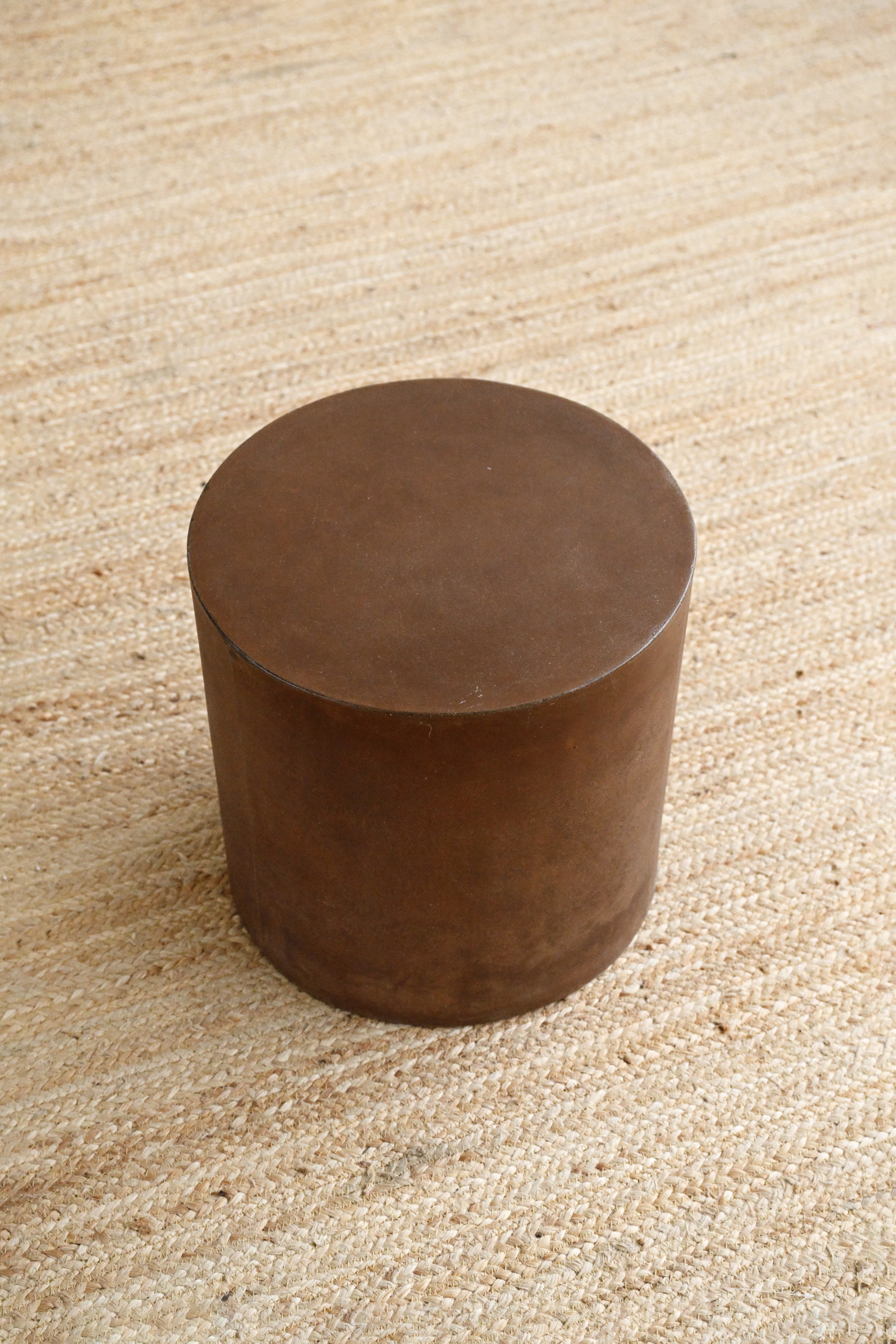 Brown cylindrical object on a textured beige surface