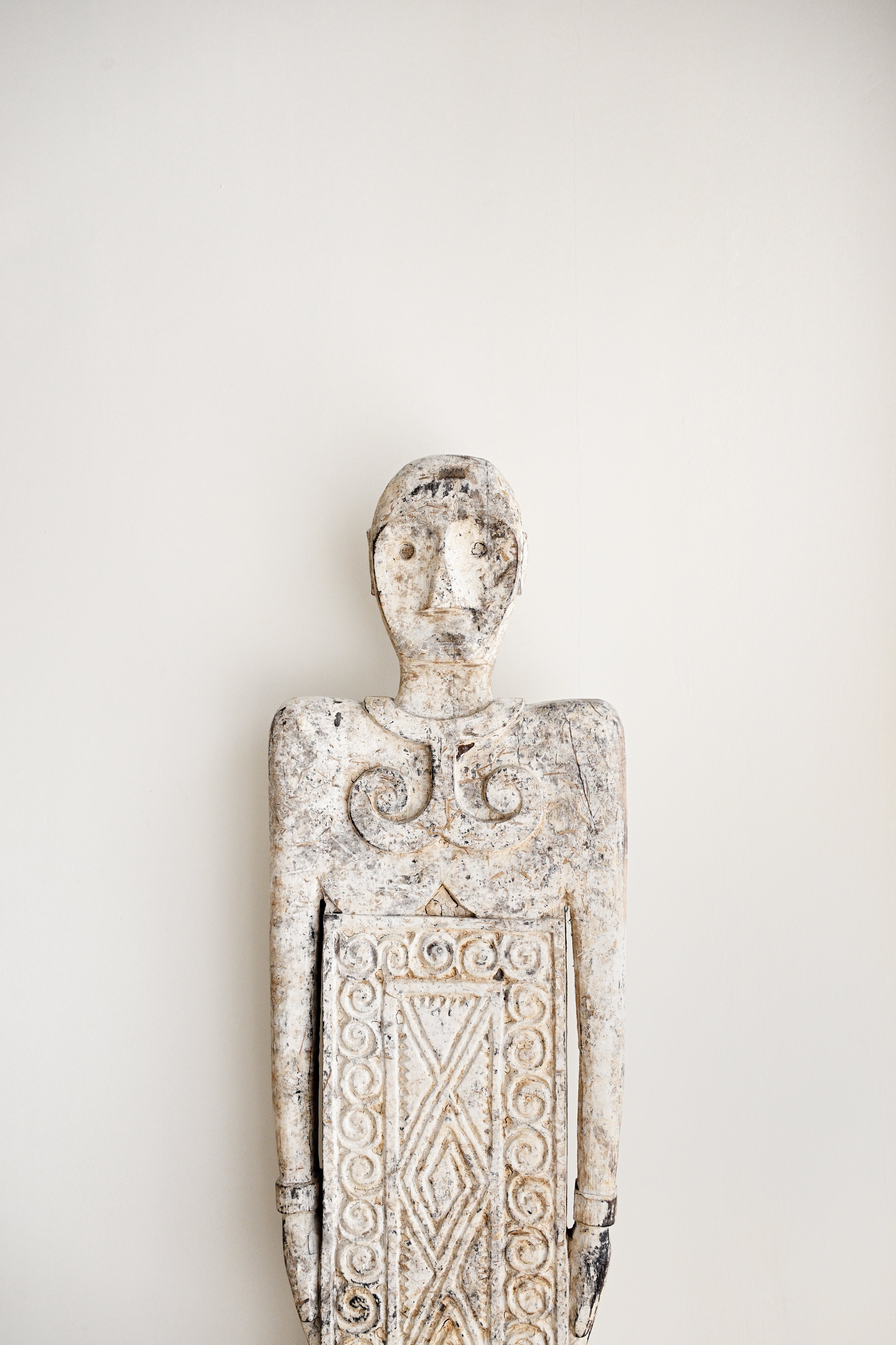 Decorative wall sculpture with intricate patterns on a plain background