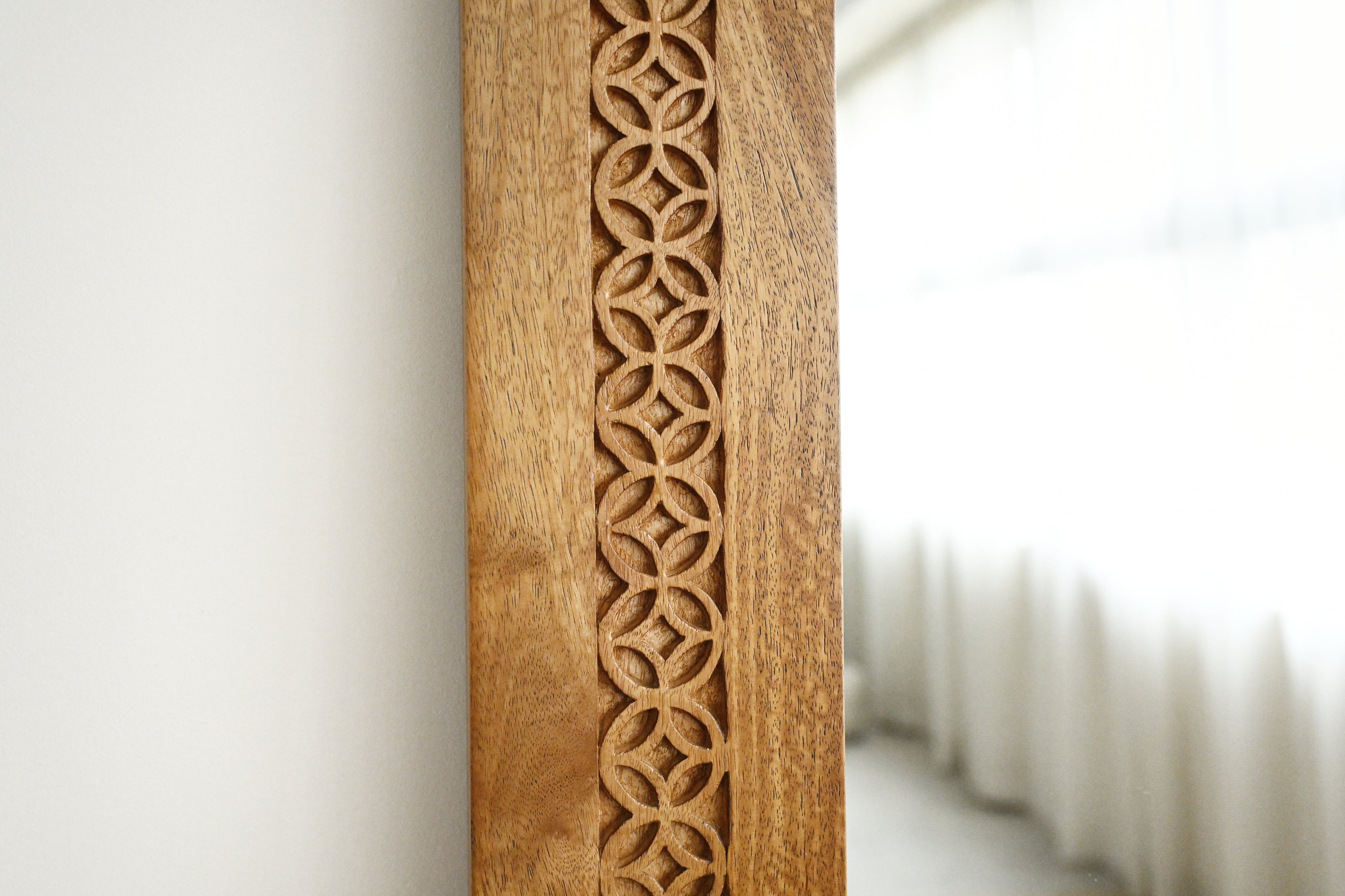 Wooden frame with intricate carvings on a white background