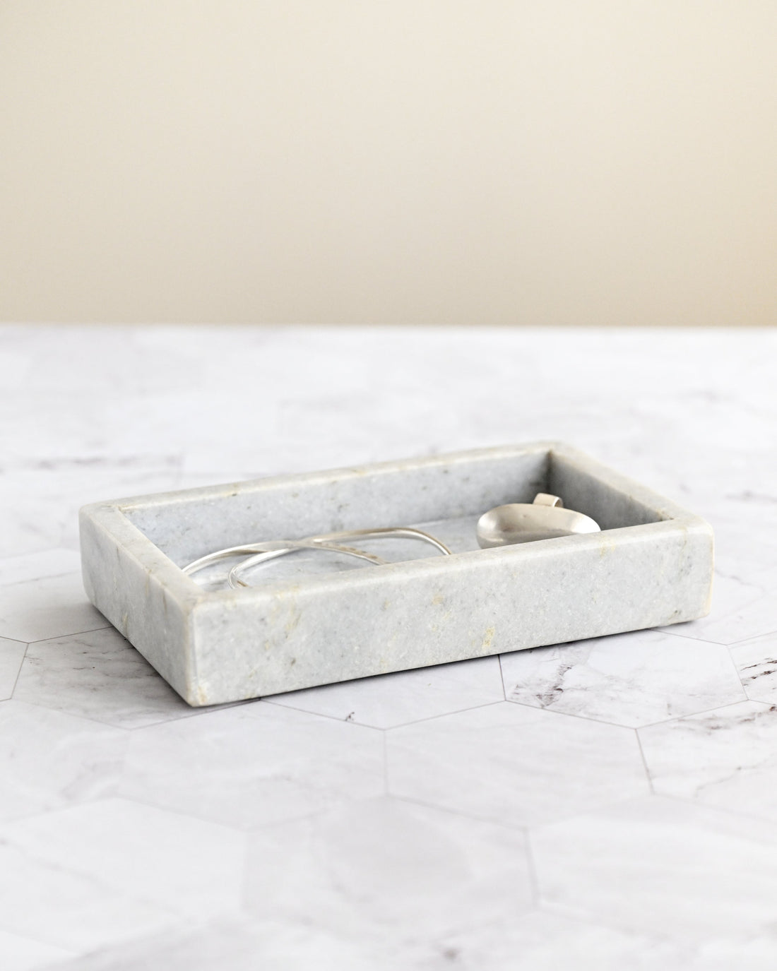 Marble tray on a marble surface with a neutral background