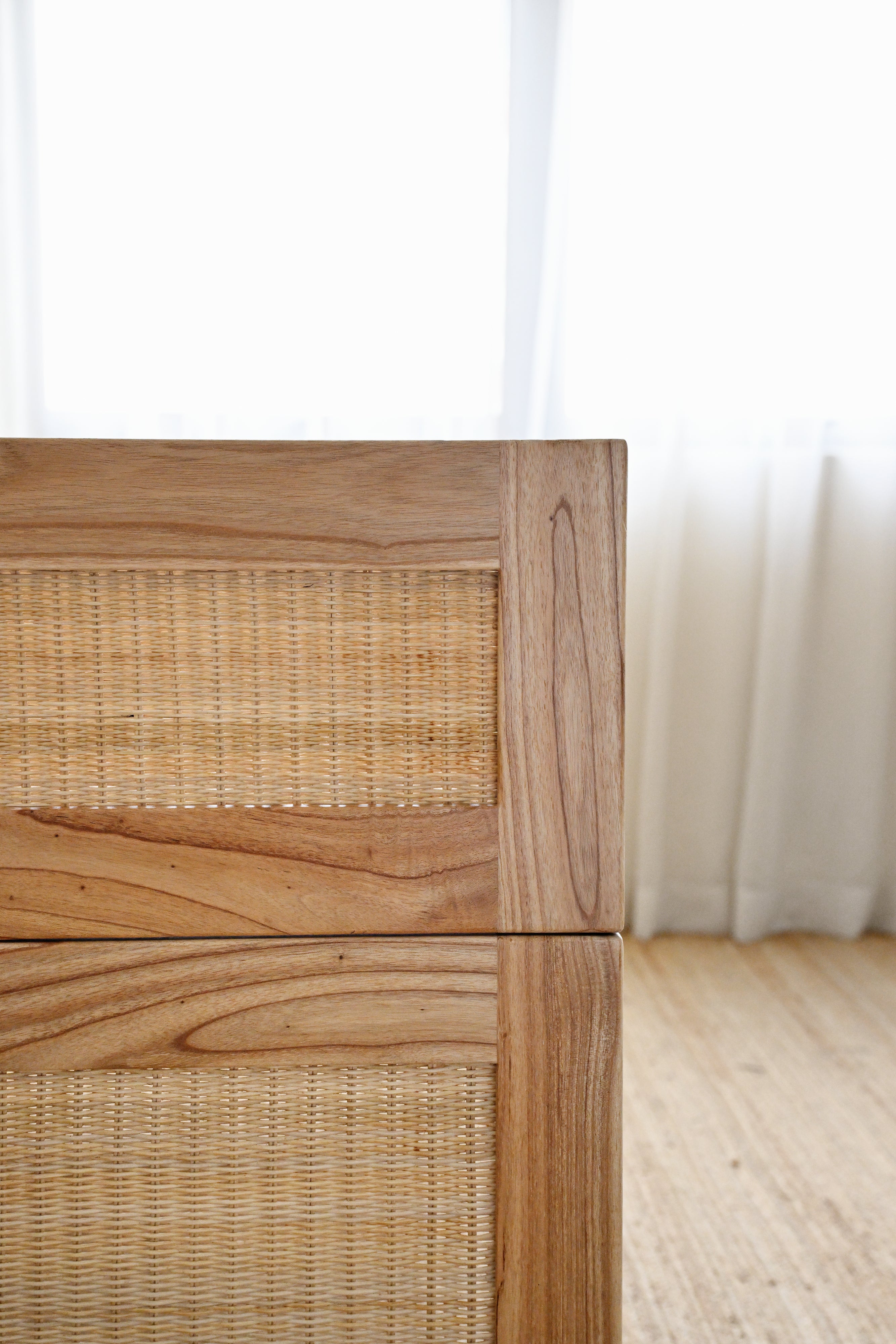 Wooden drawer with wicker pattern on a light wooden floor.