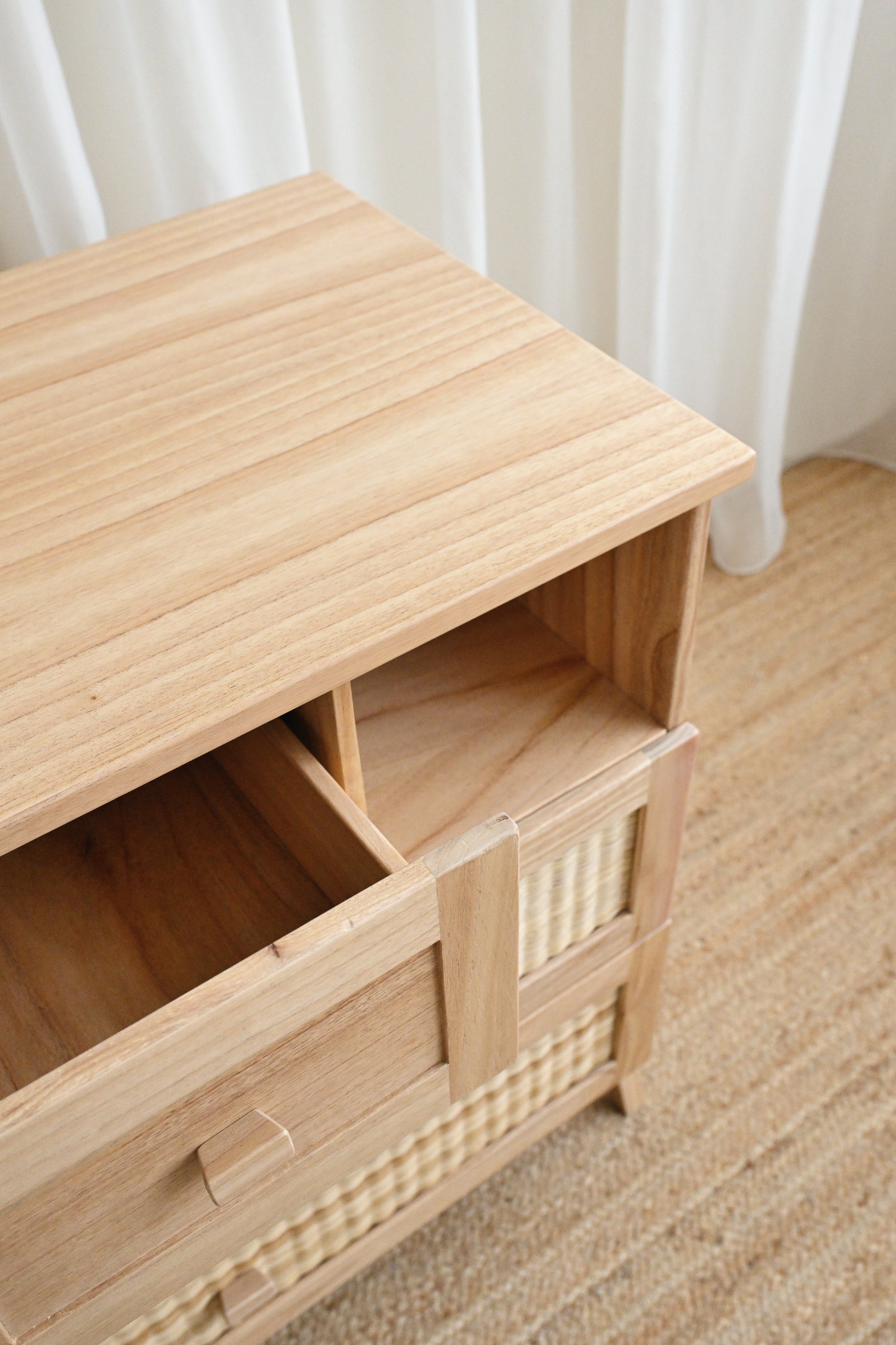 Wooden cabinet with a woven basket on a wooden floor