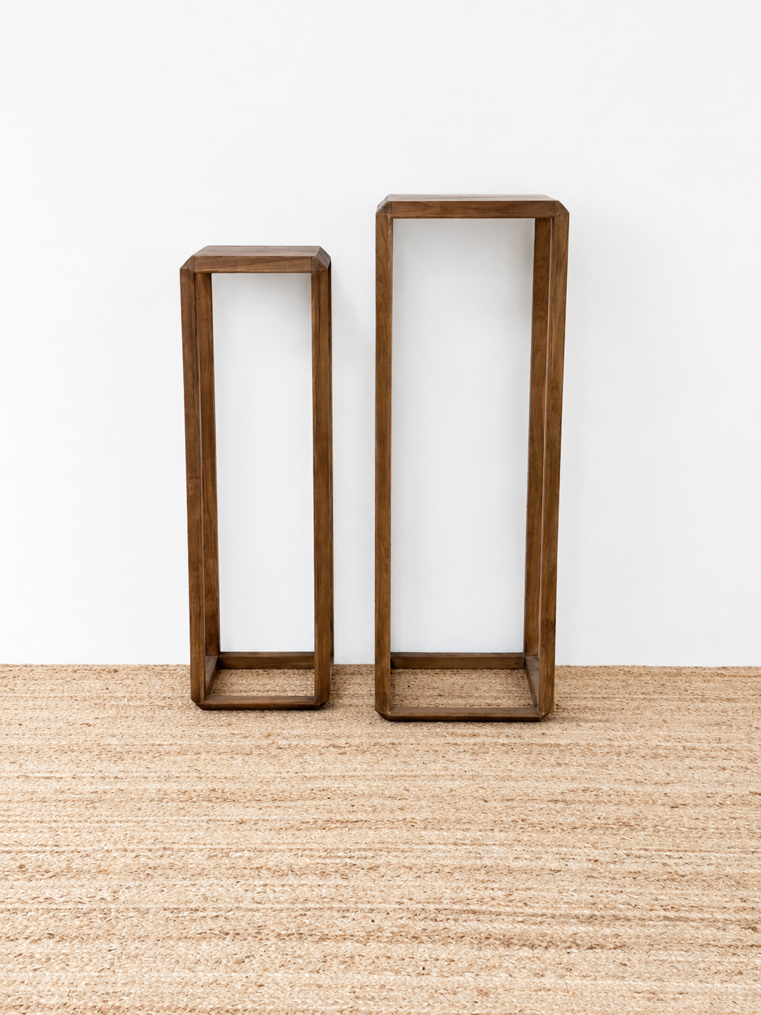 Two wooden shelves of different sizes on a neutral background