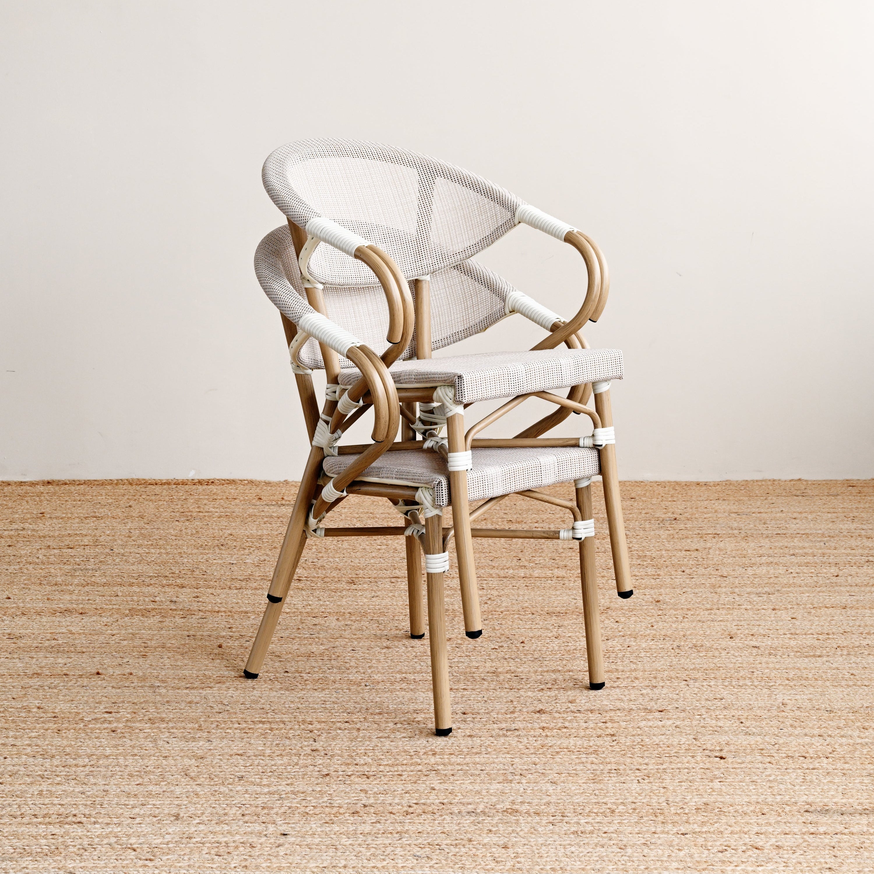Chair with white cushion on a beige floor and light gray wall