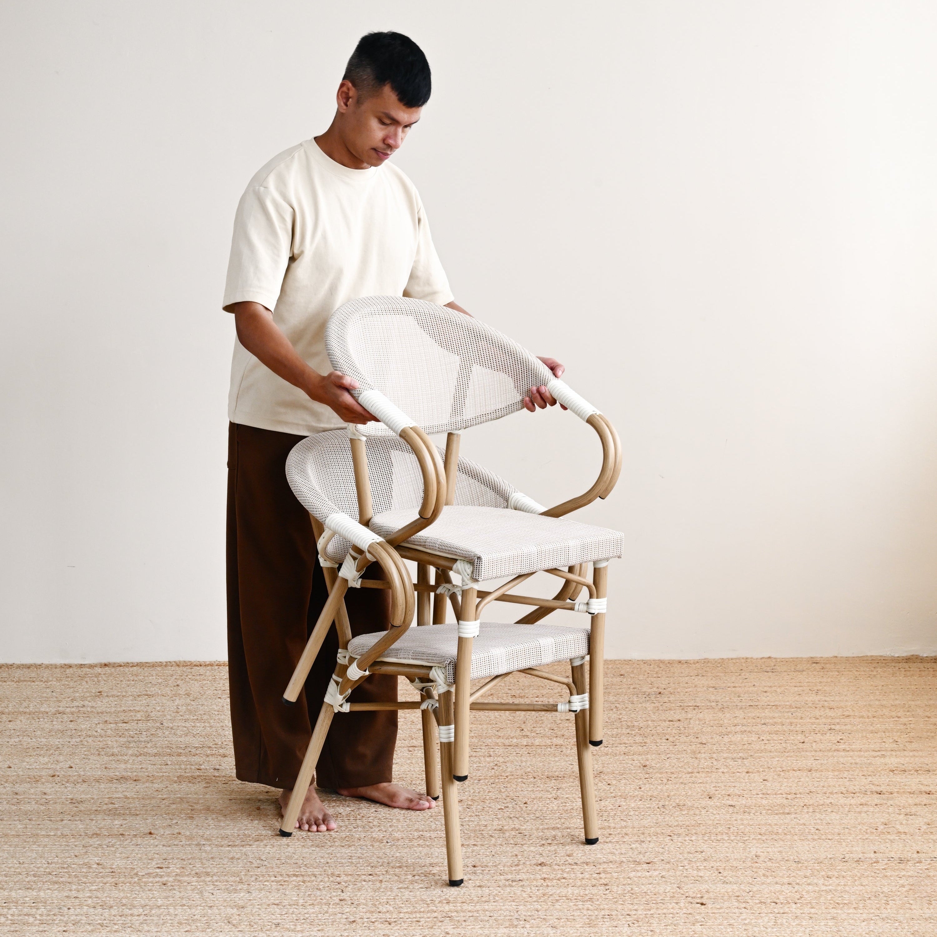Person assembling a chair in a minimalistic setting