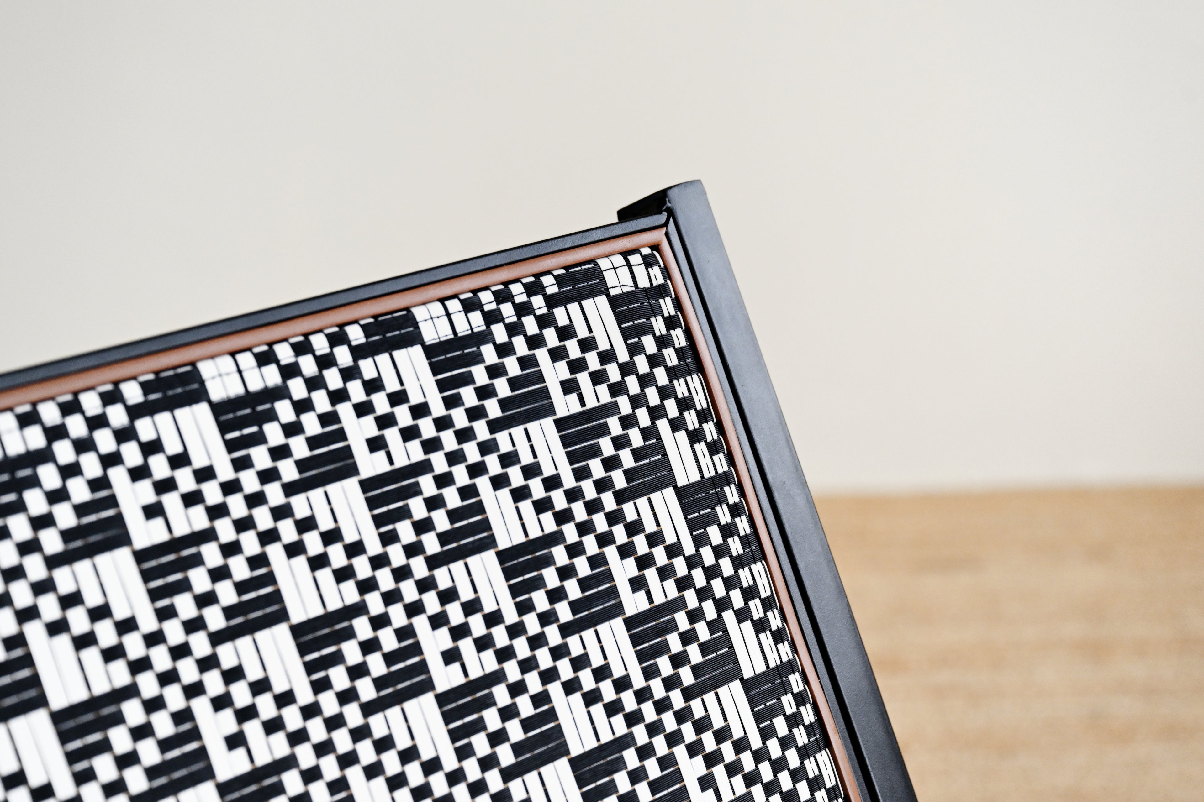 Close-up of a black and white geometric patterned object on a light background