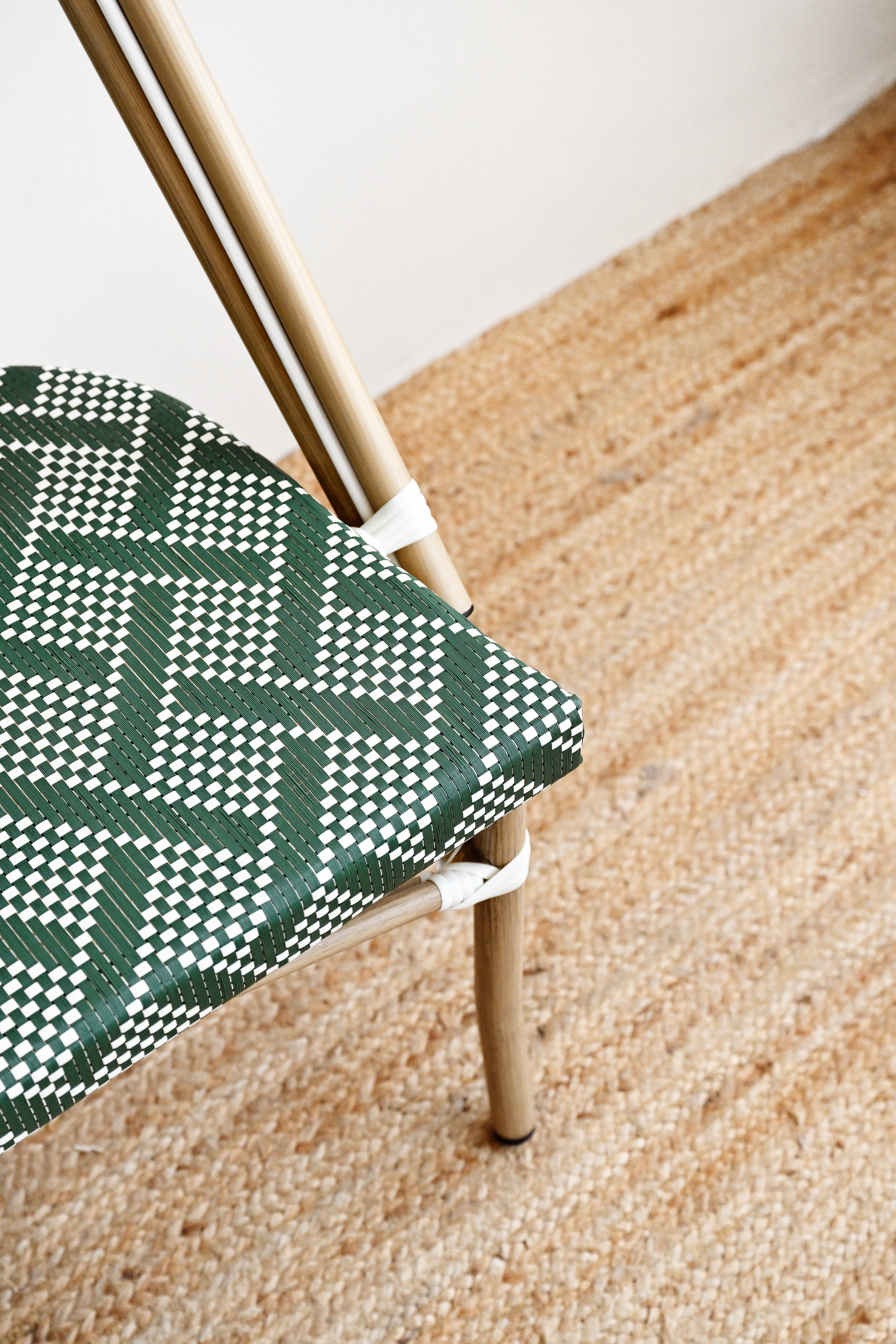 Chair with green and white patterned seat on a wooden floor