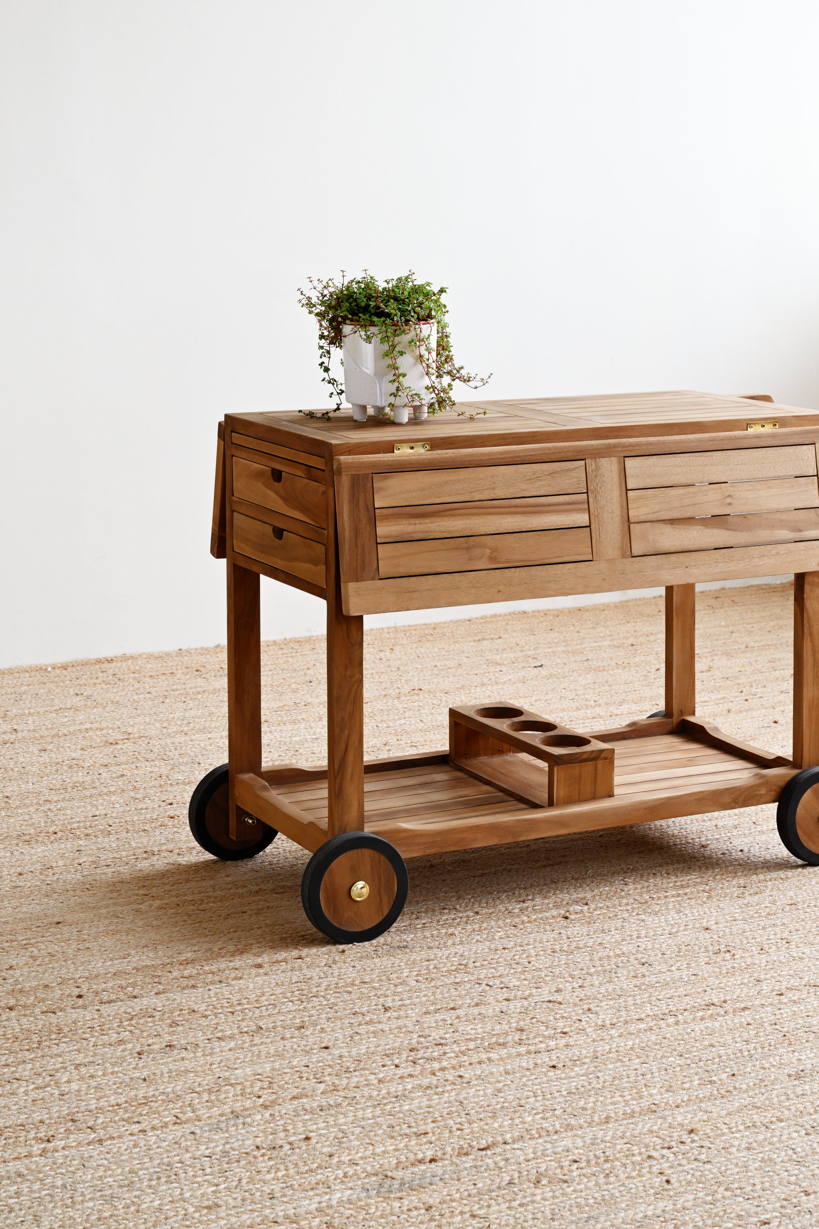 Wooden cart with drawers on a textured floor