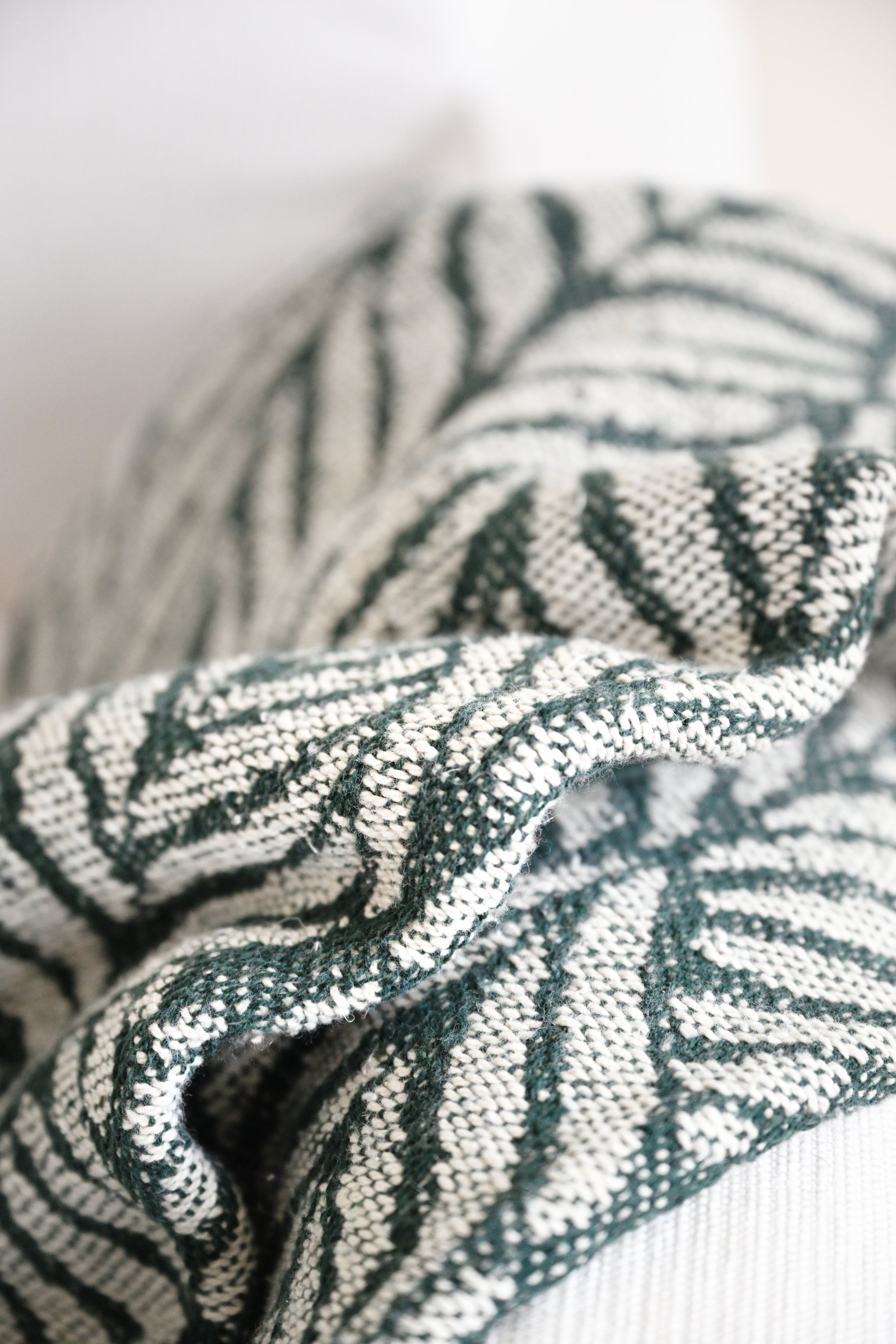 Textured fabric with a leaf pattern on a neutral background