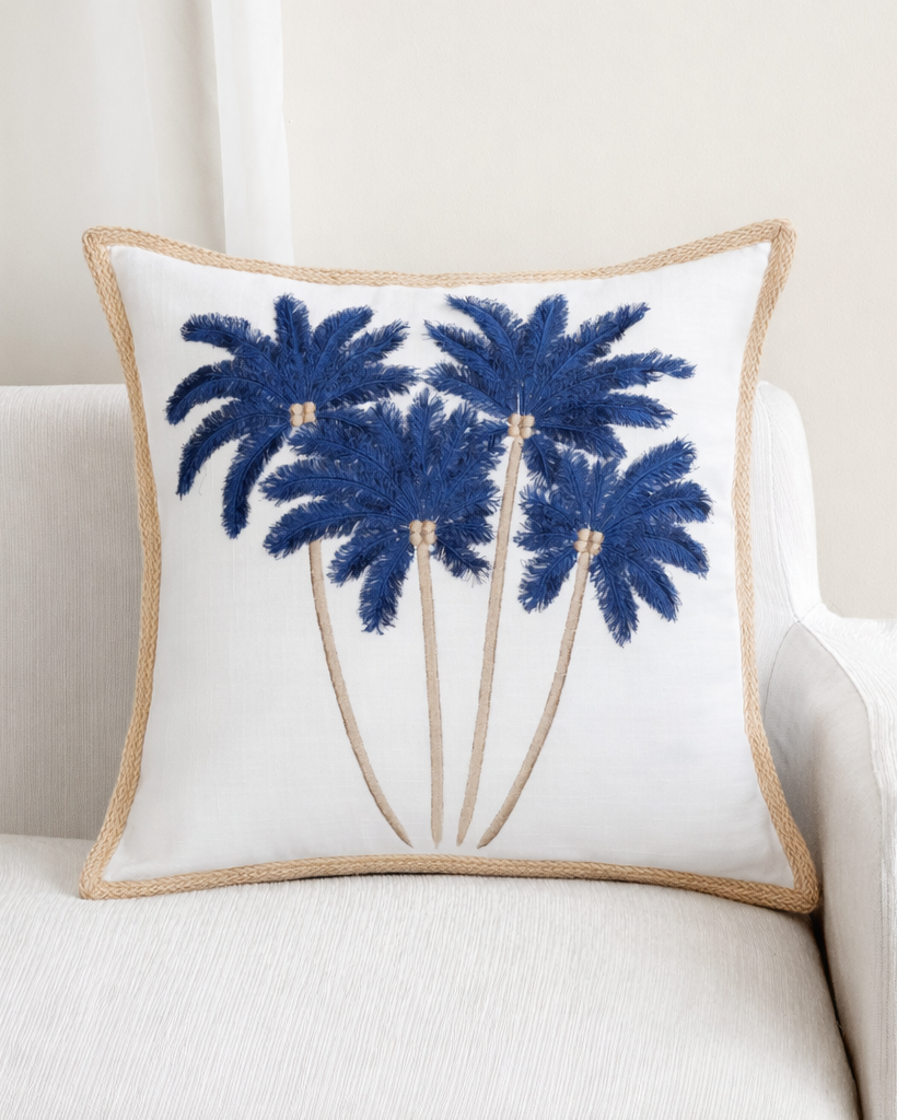 Decorative pillow with embroidered palm trees on a white background