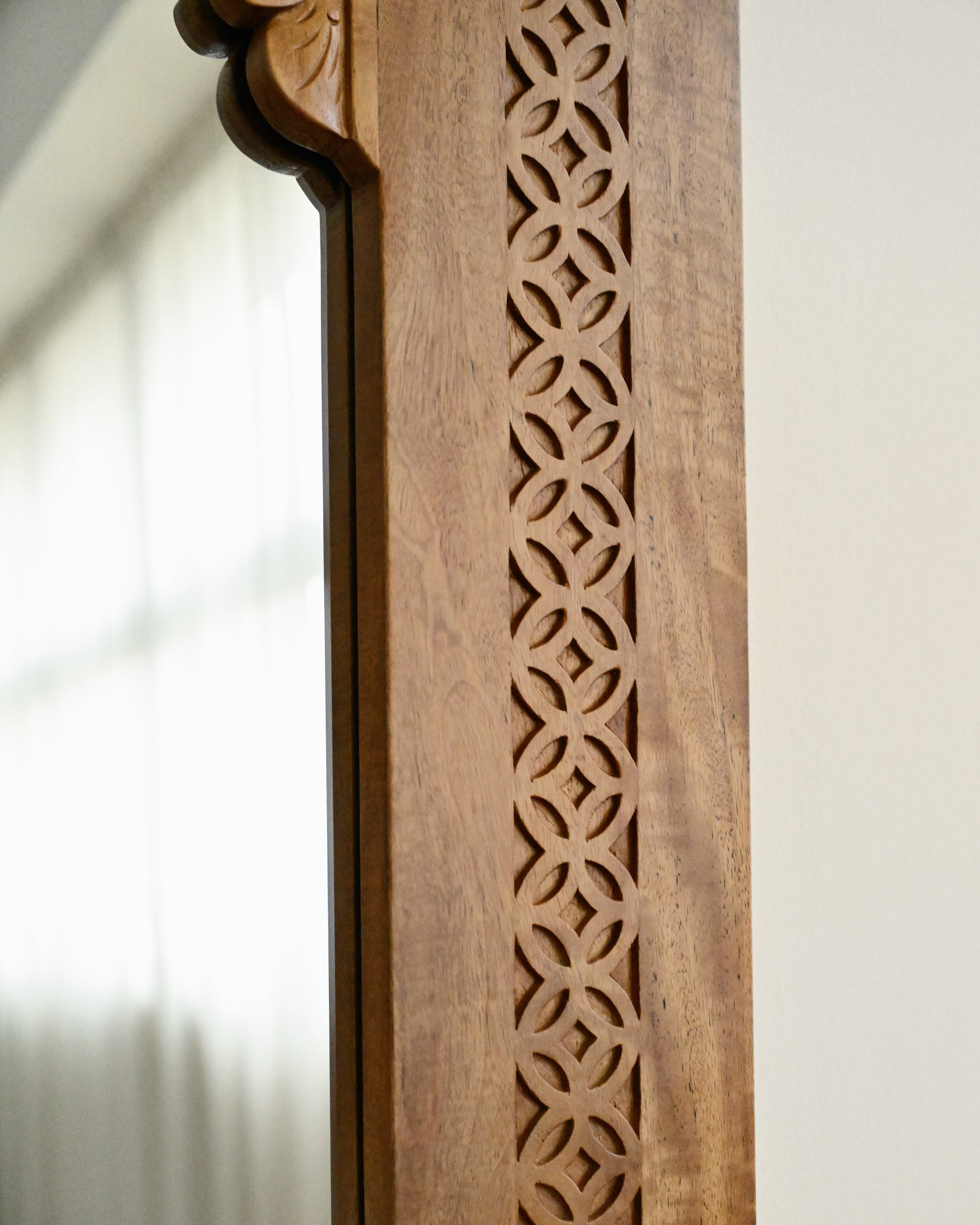 Wooden panel with intricate cut-out design on a white background