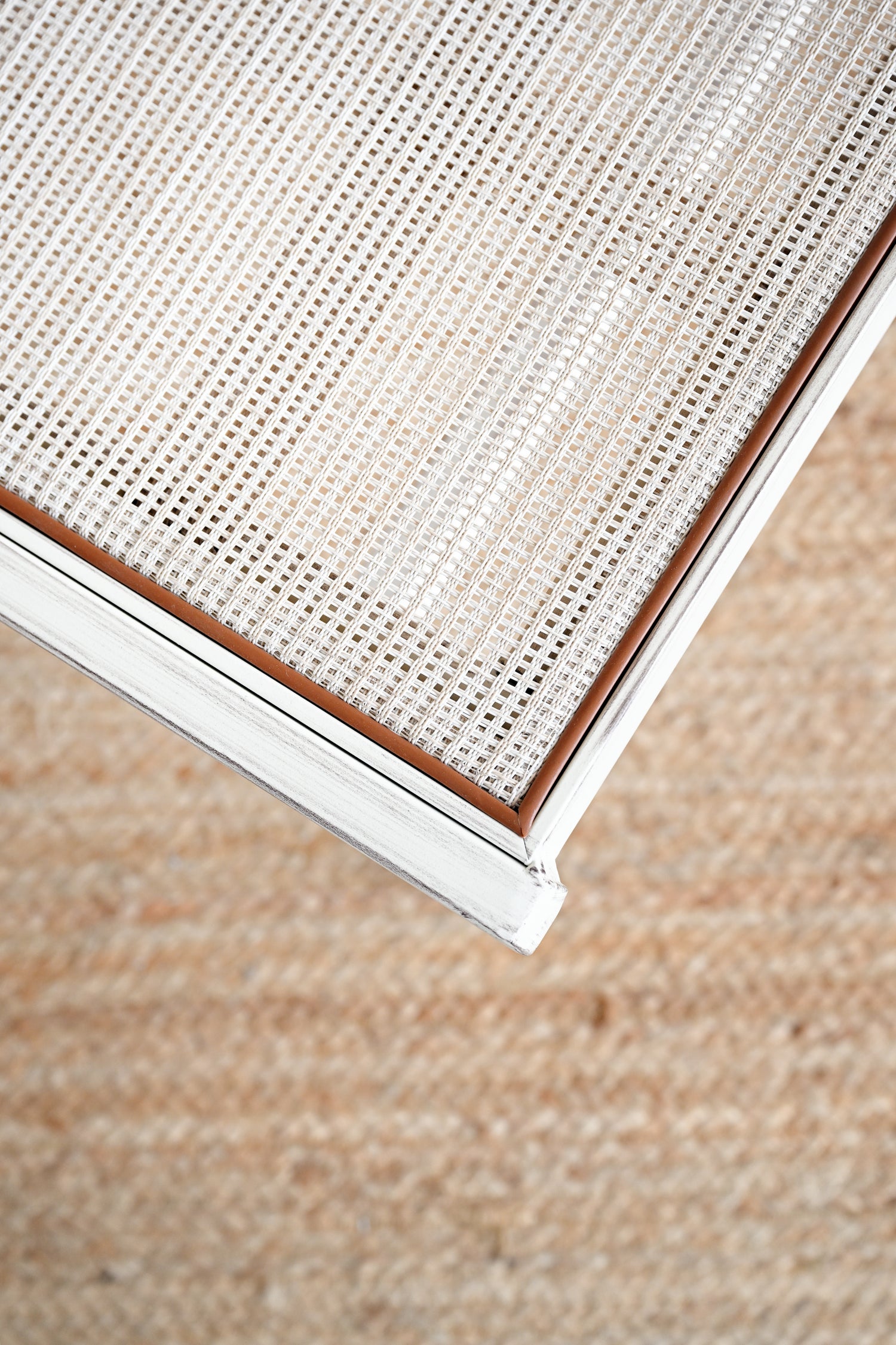 Close-up of a textured fabric surface with a neutral color palette.