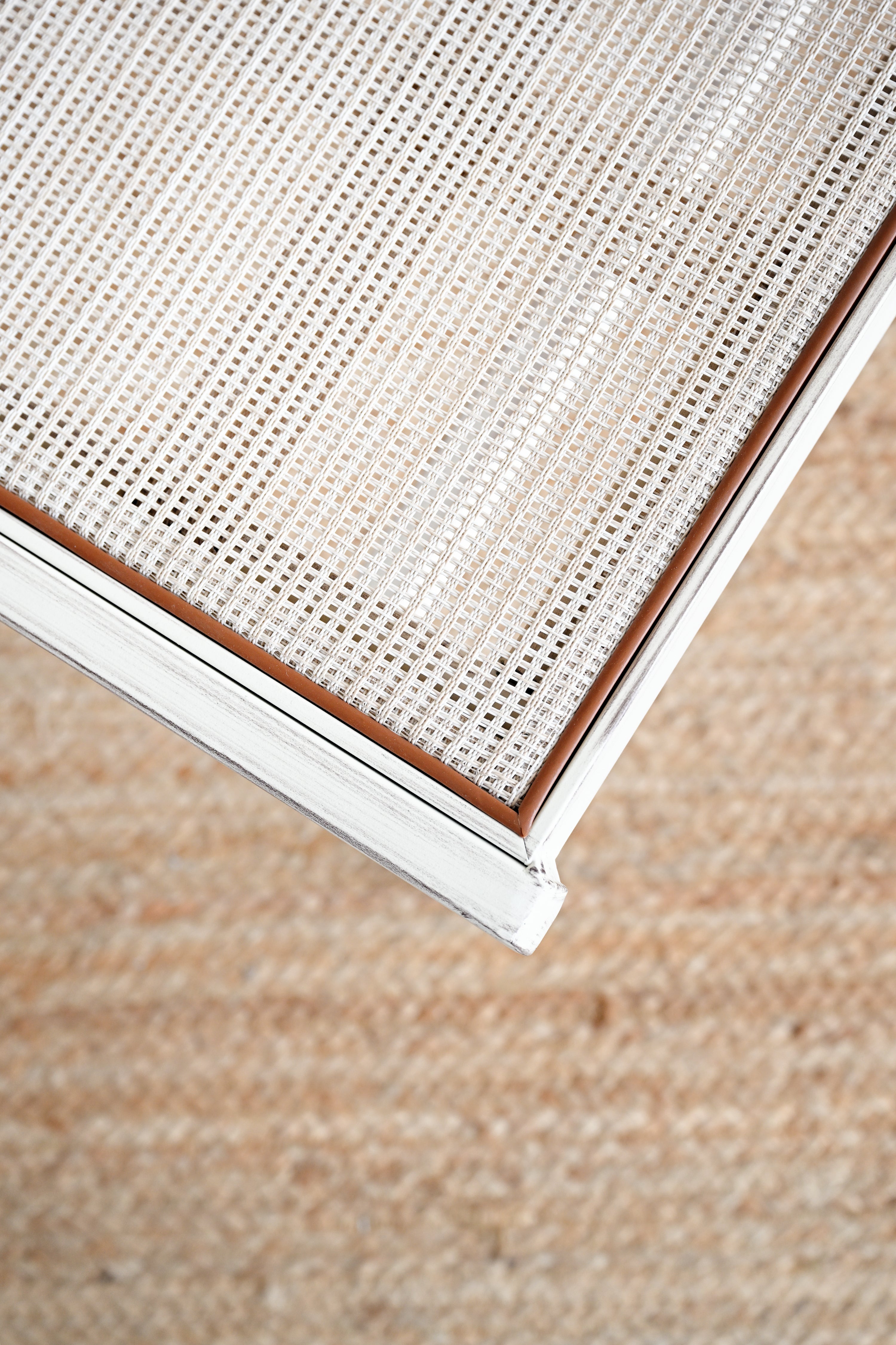 Close-up of a textured fabric surface with a neutral color palette.
