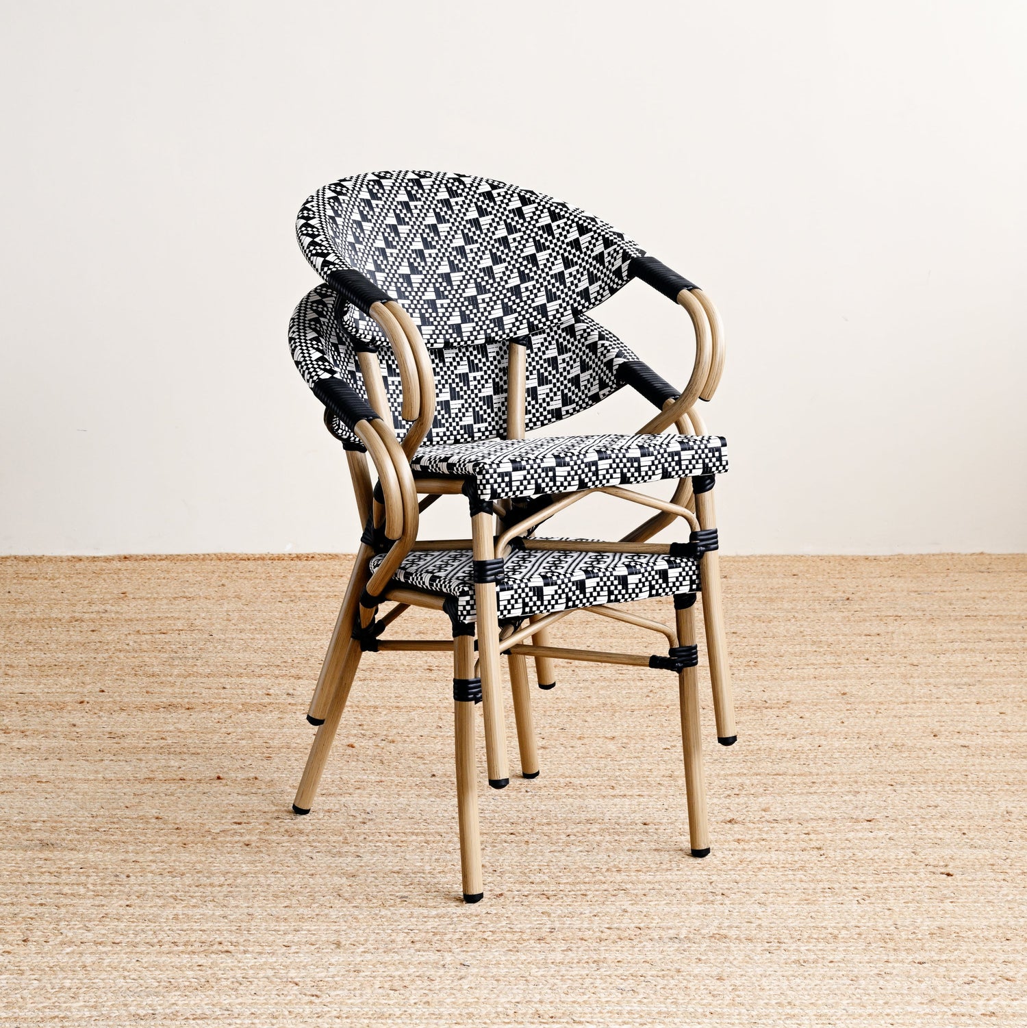 Wicker chair with patterned cushion on a beige floor and light background