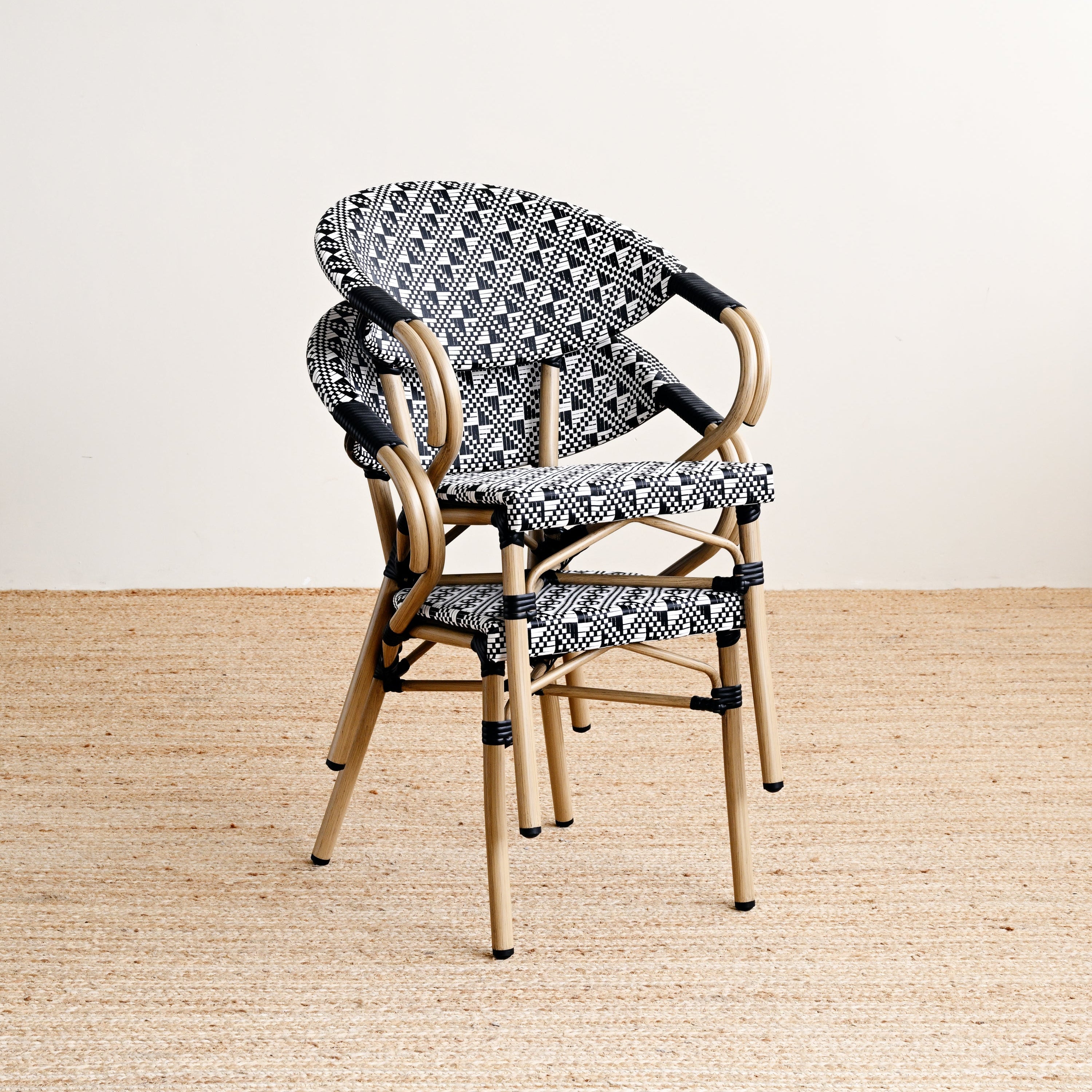 Wicker chair with patterned cushion on a beige floor and light background