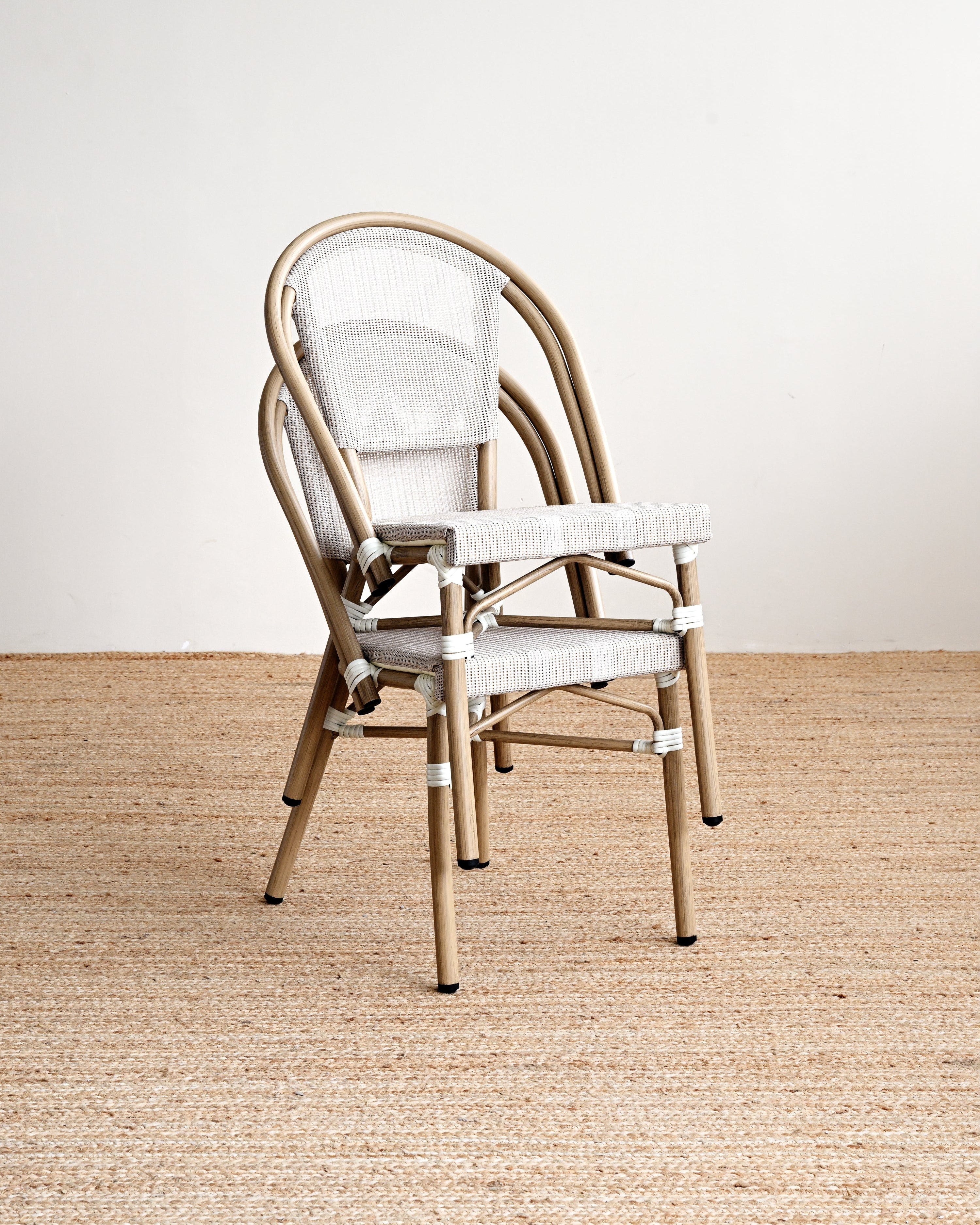 Beige metal chair with white cushion on a beige carpet