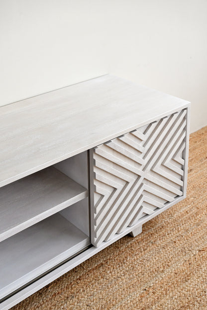 White cabinet with geometric patterned door on a beige carpet
