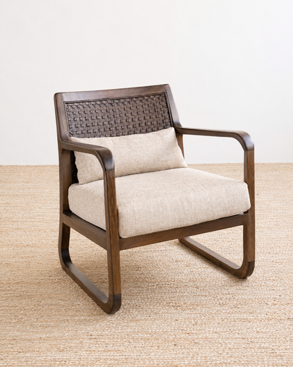 Wooden armchair with beige cushion on a textured beige floor