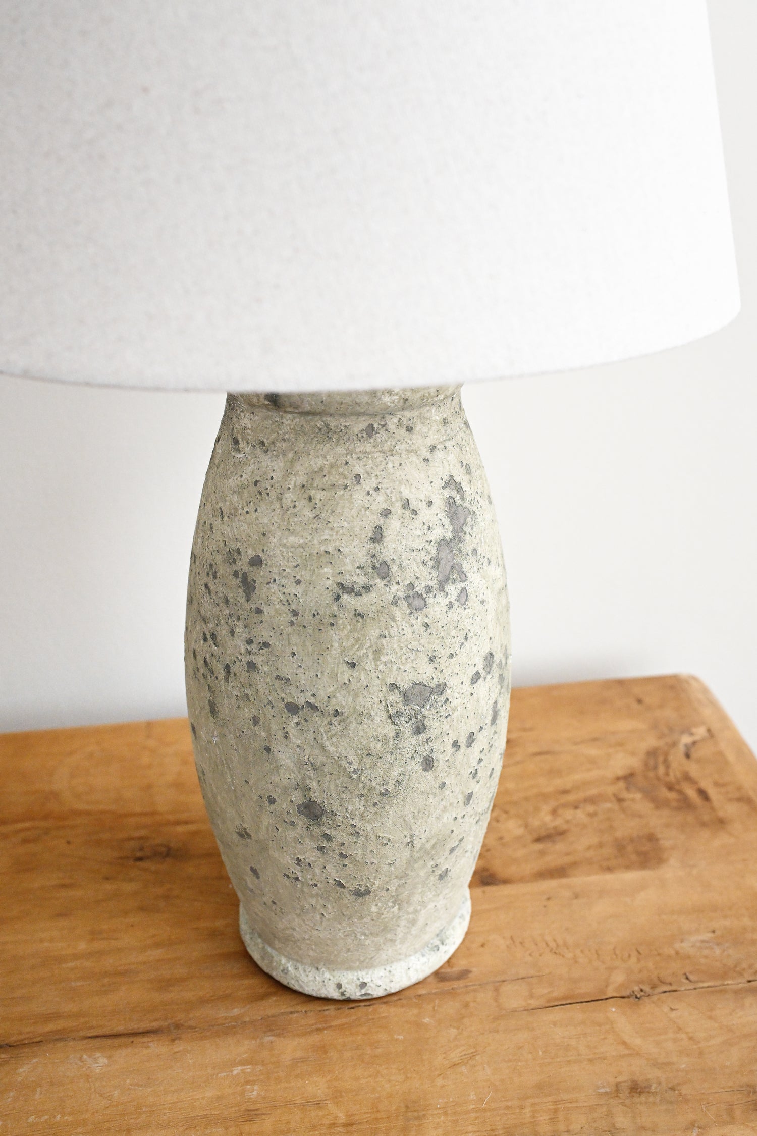 Ceramic vase on a wooden surface with a white background
