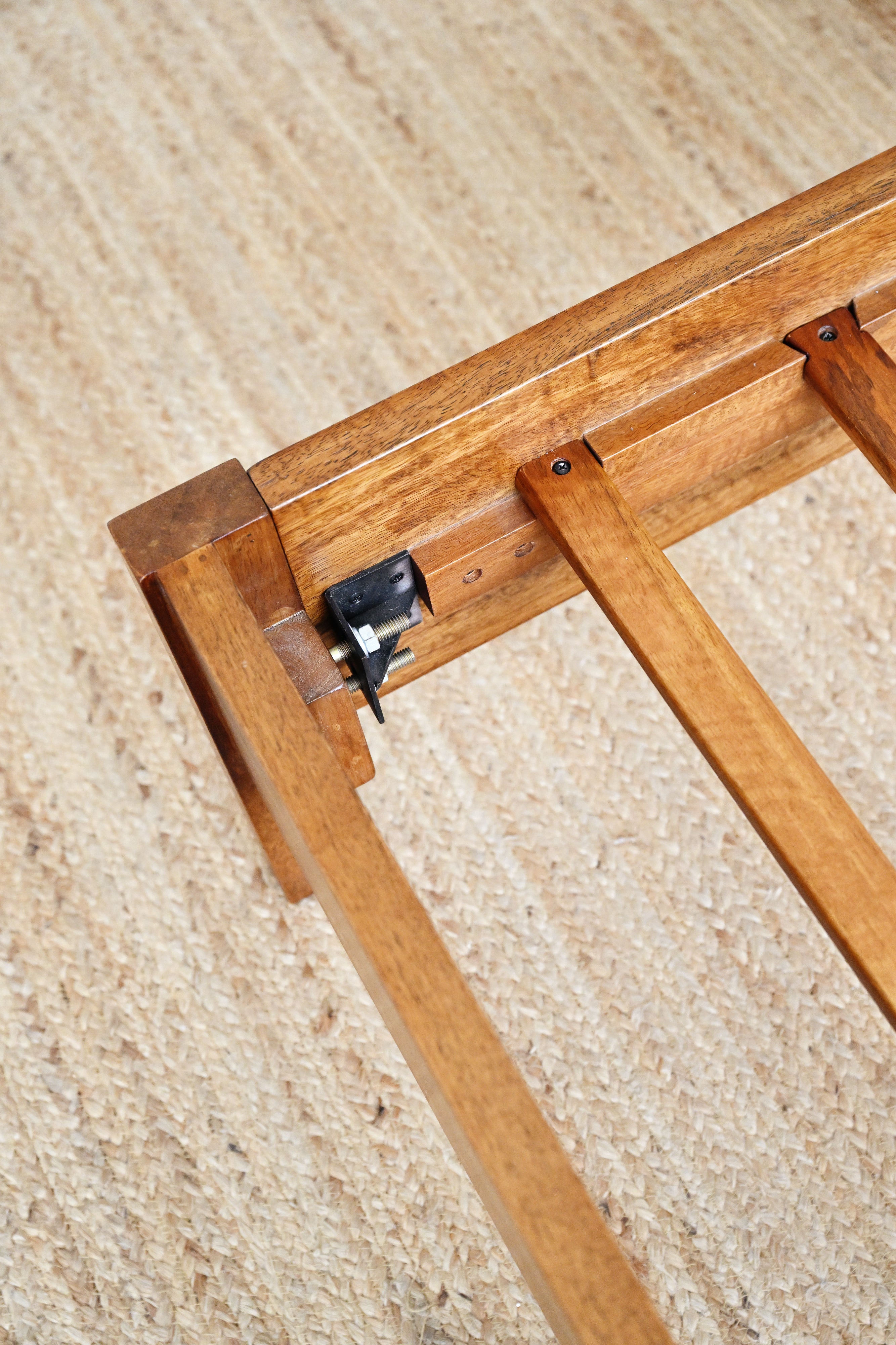 Wooden picture frame corner on a textured beige surface