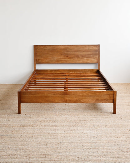 Wooden bed frame on a plain background