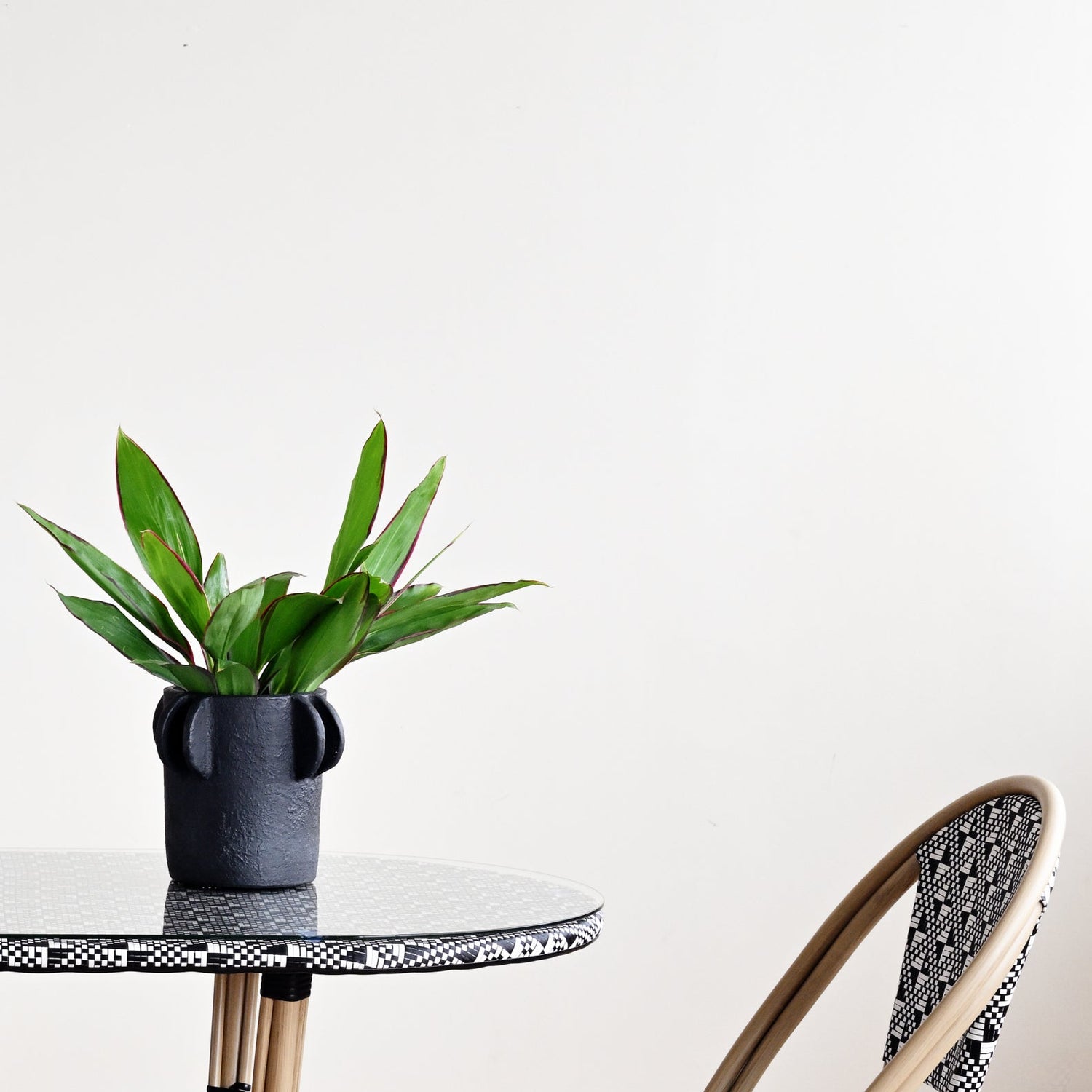 Outdoor furniture set with a table and two chairs on a wooden floor.