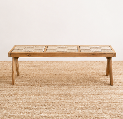 Wooden table on a textured beige floor with a plain white wall background