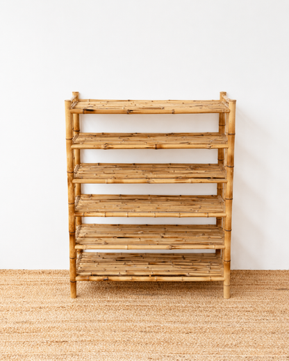 Wooden shelf with multiple shelves on a plain background