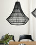 Black woven pendant light fixture hanging above a dining table with chairs.
