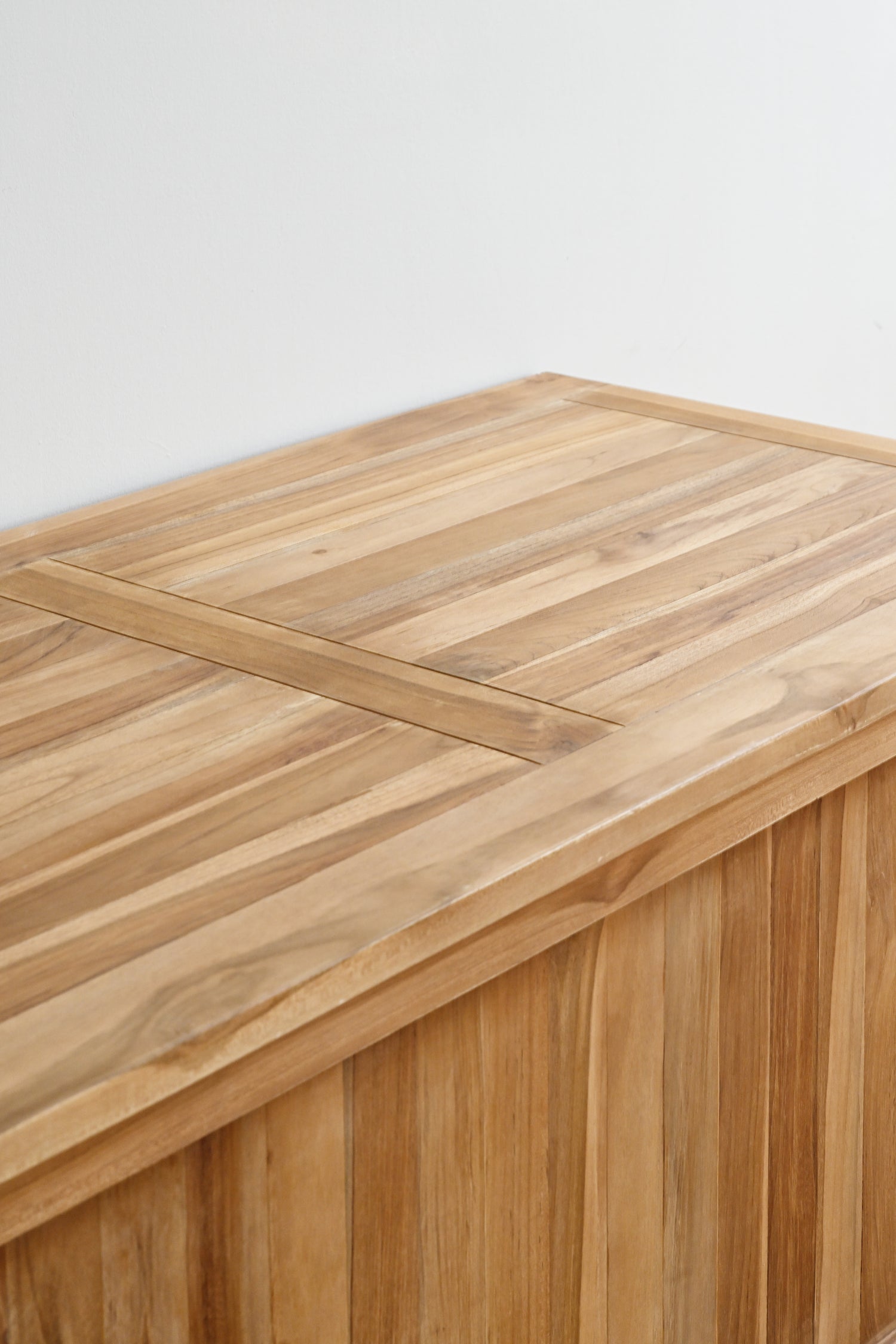 Wooden table with a light brown finish on a white background