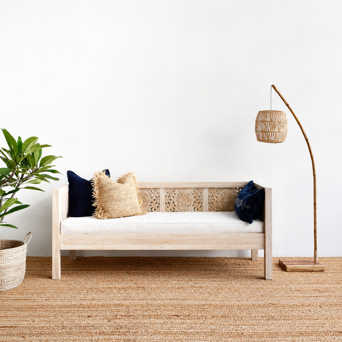 Wooden bench with cushions in a minimalistic room with a plant and lamp.