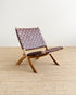 Wooden chair with woven backrest on a beige carpet