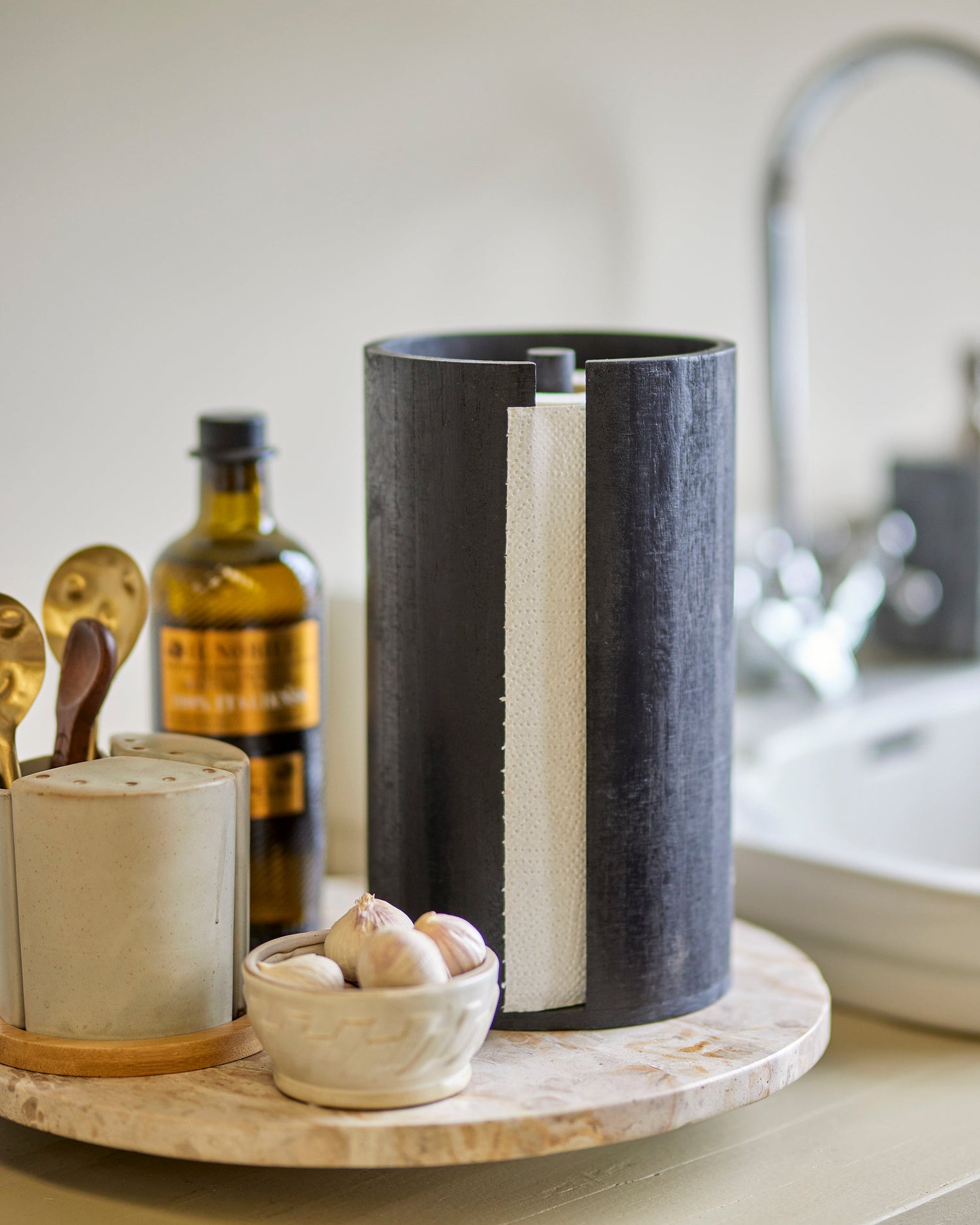 Black cylindrical container with white interior on a kitchen counter