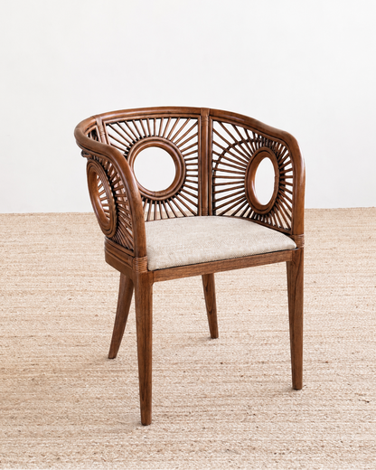 Wooden chair with a woven backrest and cushion on a textured surface