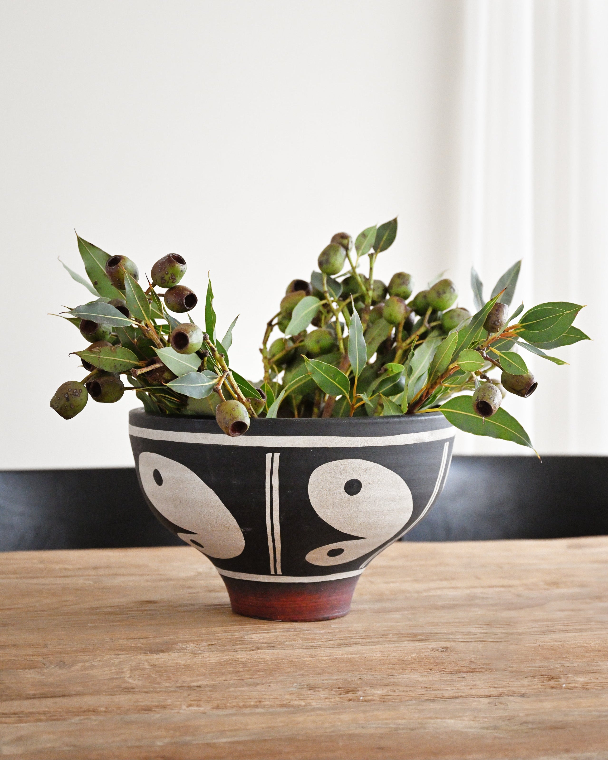 Decorative bowl with plants on a wooden table