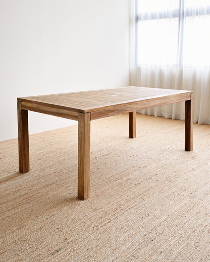 Wooden table in a room with a window and curtains