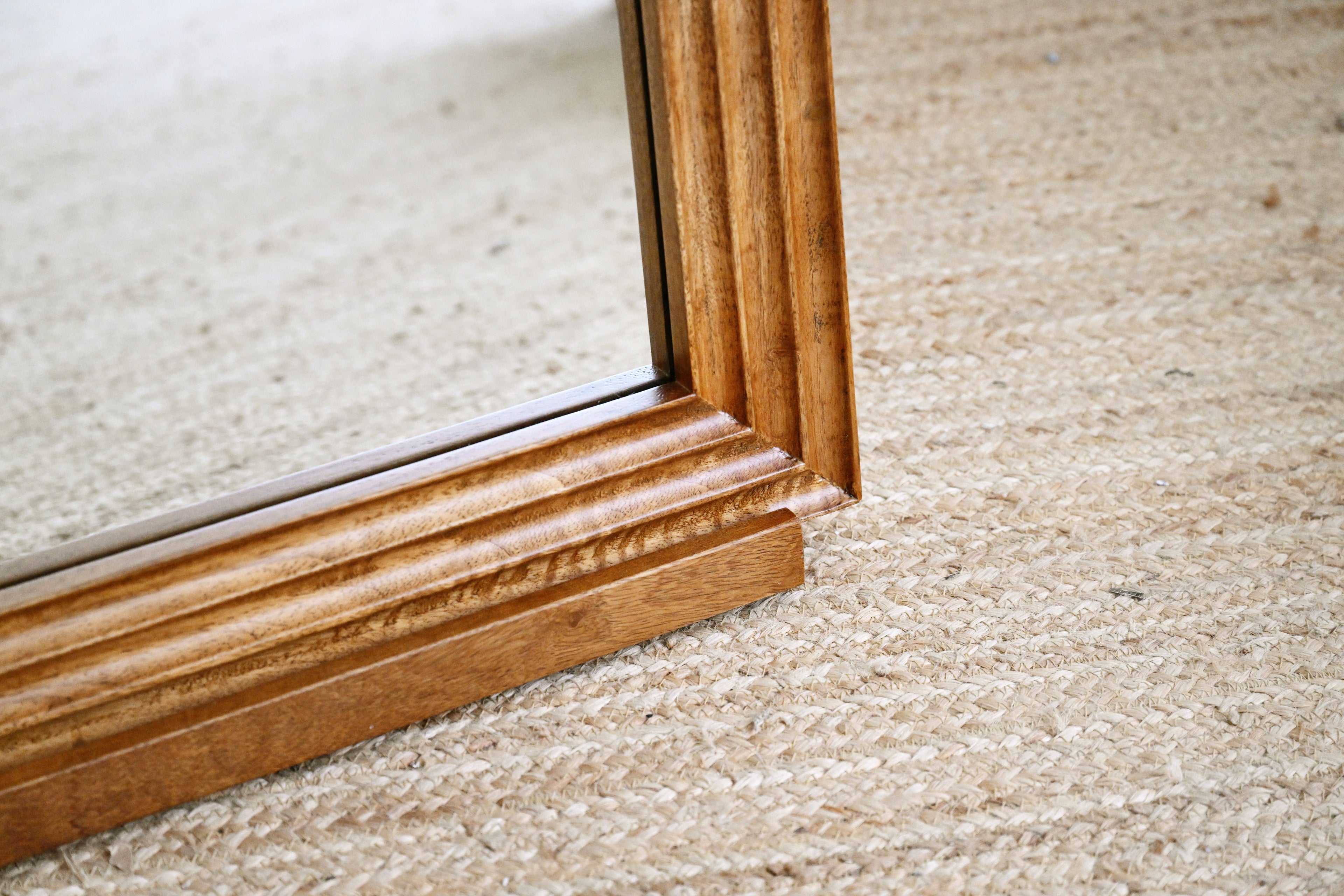 Close-up of a wooden frame on a carpeted floor