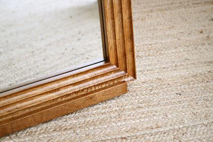 Close-up of a wooden frame on a carpeted floor
