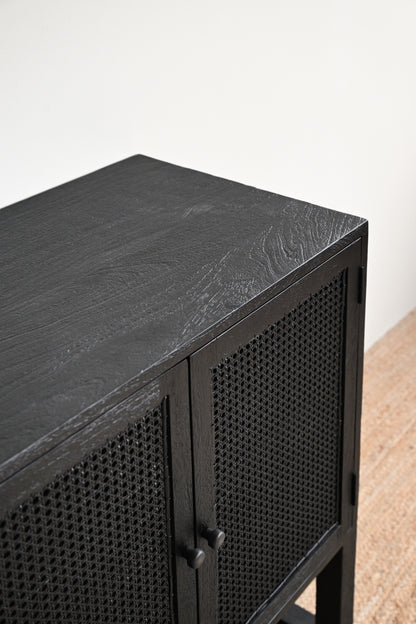 Black cabinet with woven design on a white background