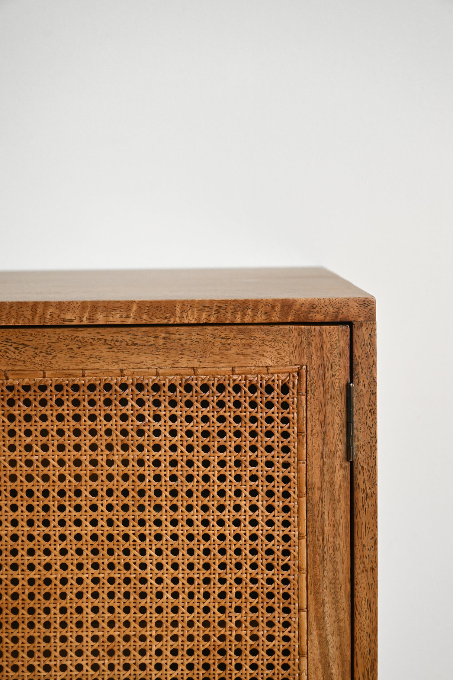 Wooden cabinet with wicker door on a white background